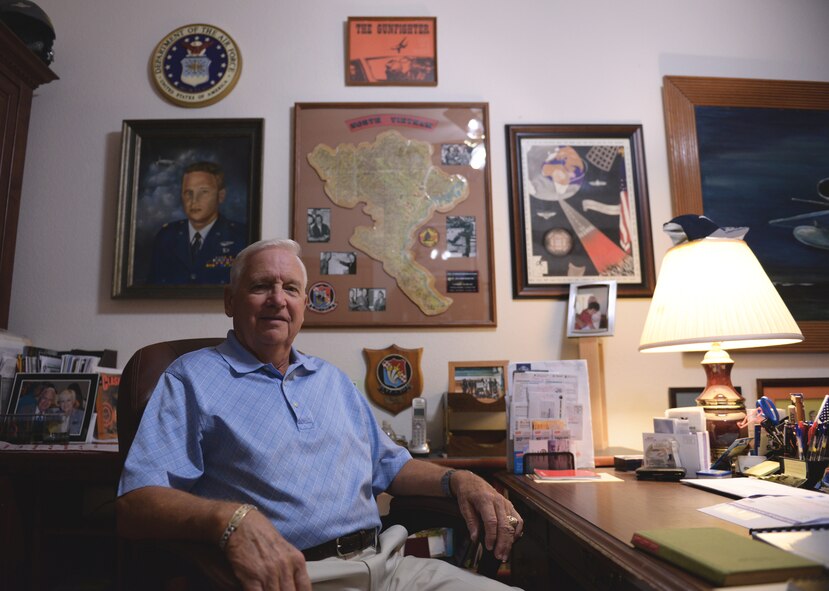 Retired Col. Ronald Lord, former fighter pilot, sits in front of a number of accolades and memorabilia in his office, Oct. 26, 2015, in Goodyear, Ariz. Lord flew approximately 300 combat missions during the Vietnam war. (U.S. Air Force photo by Airman 1st Class Ridge Shan)