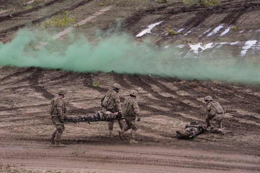 U.S. Army soldiers transfer wounded Hungarian Defense Force exercise participants to a casualty collection point during a joint live-fire exercise as part of NATO Exercise Brave Warrior 2015 at Bakony Combat Training Centre, Veszprem, Hungary Oct. 20, 2015. Brave Warrior 2015 included joint live-fire exercises and situational training exercises designed to enhance interoperability, increase operational readiness and strengthen allied relationships. (U.S. Air Force photo by Andrea Jenkins/Released)