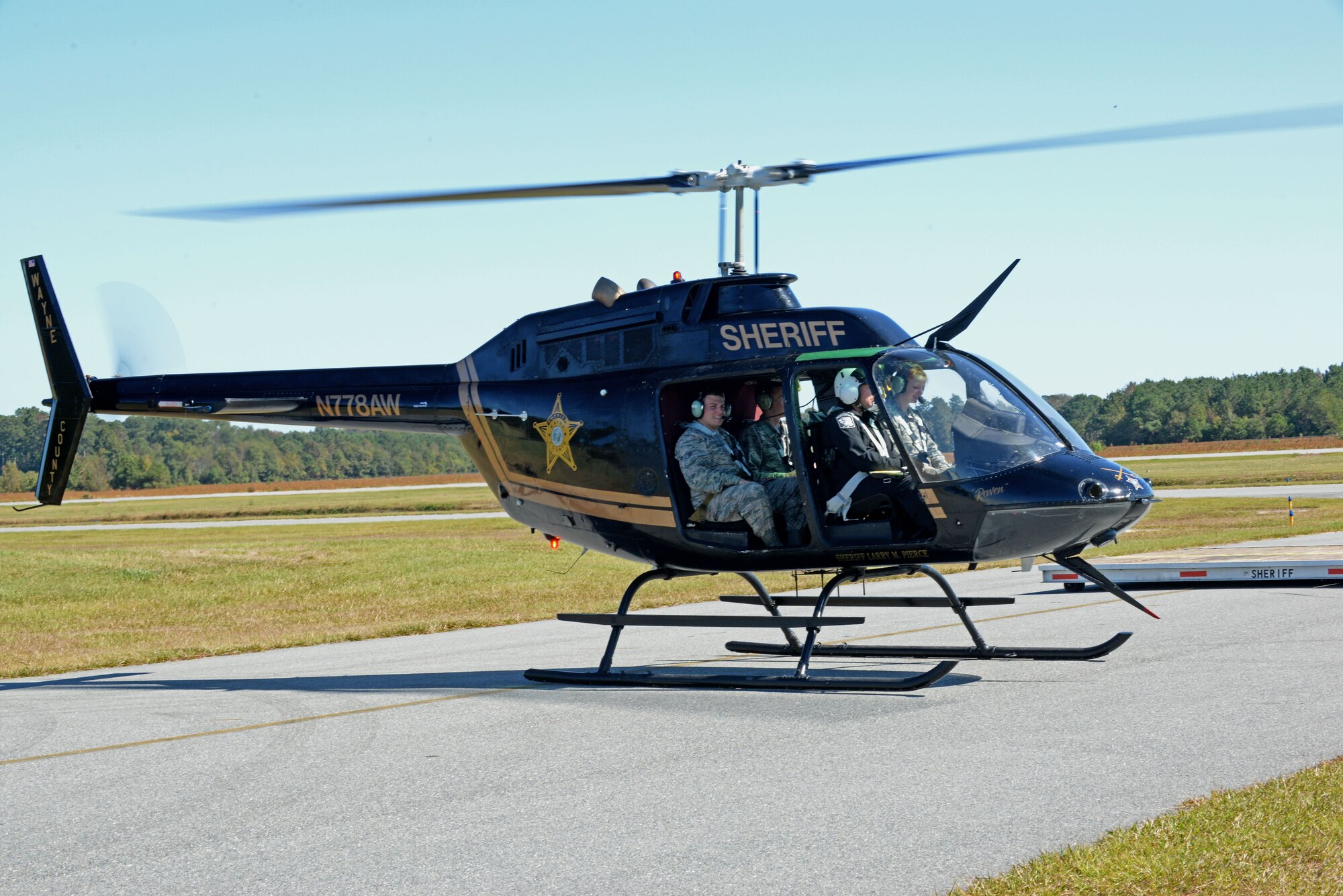 Lt. Tom Parker, Wayne County Sheriff’s Office aviation unit chief pilot, and Team Seymour Airmen land at the Wayne Executive Jetport, Goldsboro, North Carolina following an incentive flight, Oct. 21, 2015. The WCSO aviation unit flew 12 Team Seymour Airmen after discussing the importance of interoperability between the sheriff’s office and the base. (U.S. Air Force photo/Airman 1st Class Ashley Williamson)