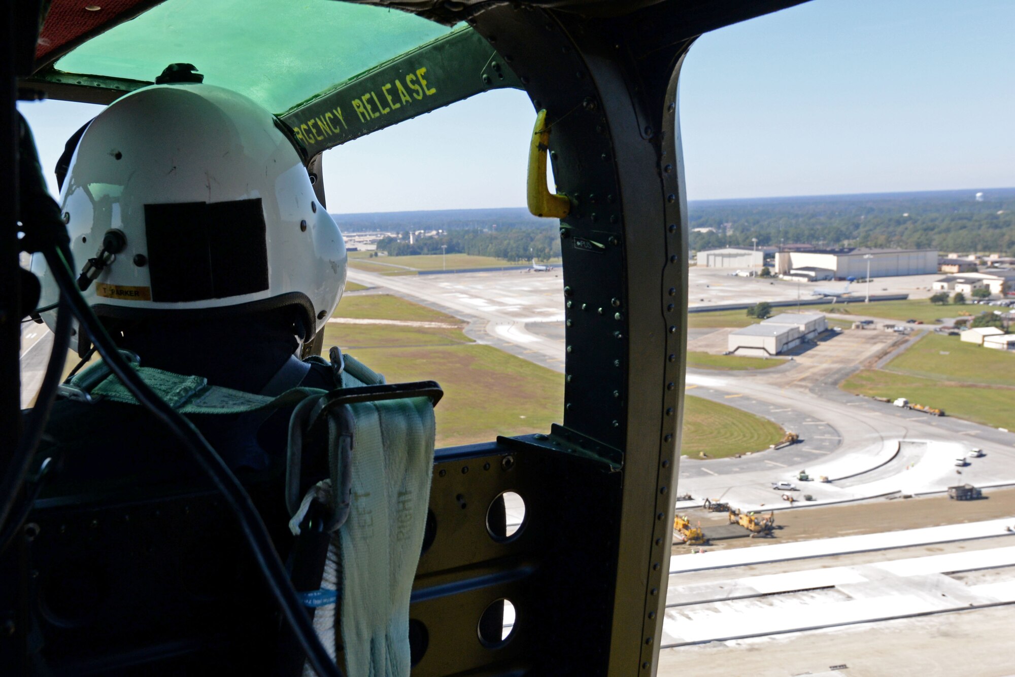 Lt. Tom Parker, Wayne County Sheriff’s Office aviation unit chief pilot, gazes at the flight line on Seymour Johnson Air Force Base, North Carolina while giving Team Seymour Airmen an incentive flight, Oct. 21, 2015. Communication and coordination between Seymour Johnson AFB and the WCSO aviation unit assists the WCSO in cracking down on crime in Wayne County. (U.S. Air Force photo/Airman 1st Class Ashley Williamson)