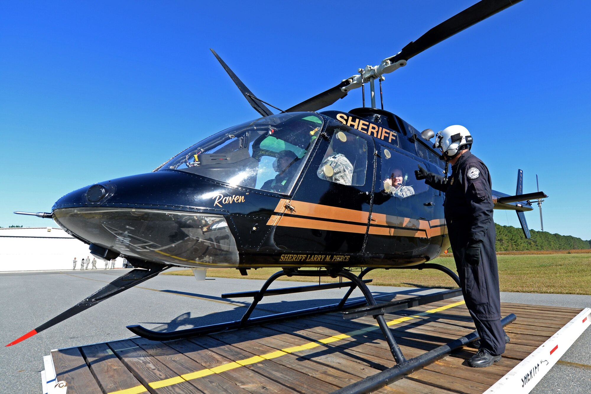 Lt. John Denny, Wayne County Sheriff’s Office aviation unit chief tactical flight officer, gives Team Seymour Airmen thumbs up before take-off, Oct. 21, 2015, at the Wayne Executive Jetport, Goldsboro, North Carolina. Team Seymour Airmen received the opportunity to participate in an incentive helicopter ride with the WCSO aviation unit after discussions arose regarding revitalizing an old program that enhanced interoperability between the forces. (U.S. Air Force photo/Airman 1st Class Ashley Williamson)