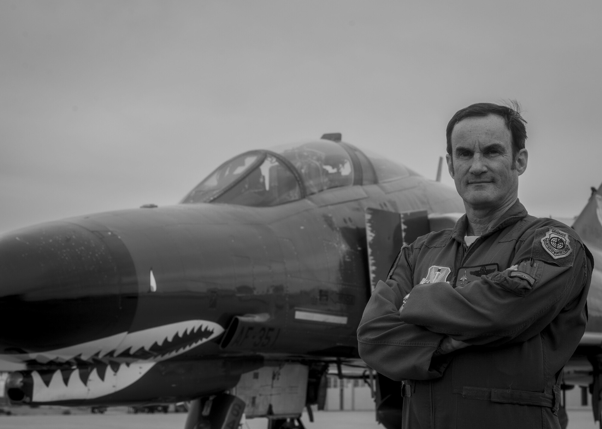 James Harkins, a QF-4 Drone pilot with the 82nd Aerial Targets Squadron, poses for a photo in front of a QF-4 on Oct. 28, 2015 at Holloman Air Force Base, N.M. Harkins was the first civilian pilot to fly 1,000 hours in a QF-4, with all of those hours flown as a civilian. He will likely be the last pilot to earn his thousand-hour patch before the QF-4 is officially retired and replaced by the QF-16 at the end of 2016. (U.S. Air Force photo by Airman 1st Class Emily A. Kenney/Released)