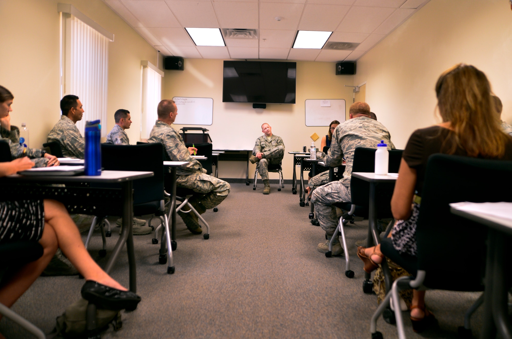Chief Master Sgt. Paul Pohnert, 799th Air Base Group chief enlisted manager, addresses helping agencies from around base during an integrated delivery system meeting Oct. 26, 2015, at Creech Air Force Base, Nevada. The IDS is a cross-functional organization consisting of key agencies such as public affairs, first sergeants council, chaplain corps, key spouses, the Creech human performance team, Airman's council and other organizations that come together to help address Airman's concerns and build resiliency. (U.S. Air Force photo by Airman 1st Class Christian Clausen/Released)