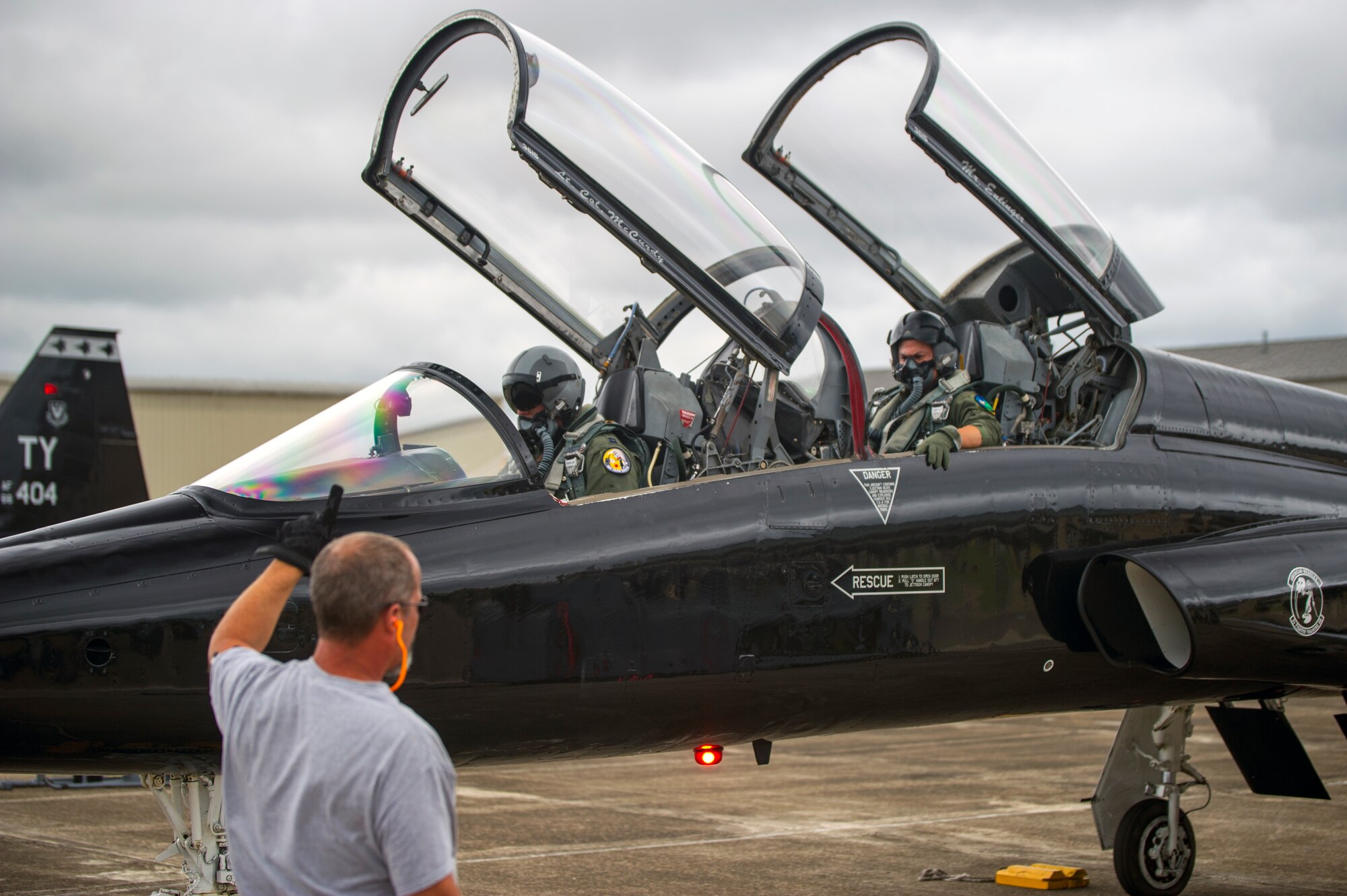 A crew chief gives Capt. Justin Hedrick (center), 2nd Fighter Training Squadron pilot, and Capt. Julio Gomez (right), 2nd Fighter Training Squadron medical doctor, a signal Oct. 27,before they take off to engage in Exercise Southern Strike at Naval Air Station Joint Reserve Base Belle Chasse, La. While Tyndall Air Force Base’s F-22 Raptor student pilots can’t get all the training they need flying with the Talons, the T-38 plays an integral role in their training. (U.S. Air Force photo by Staff Sgt. Russ Jackson)