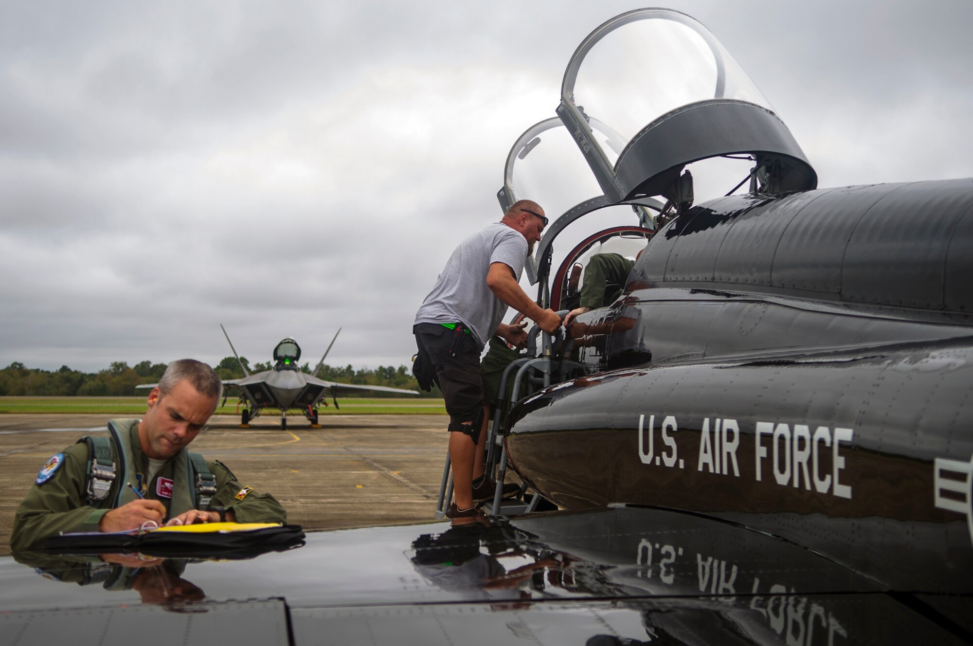 Lieutenant Col. Michael Dunyak, 2nd Fighter Training Squadron pilot, writes on a flight plan Oct. 27,after flying a T-38 Talon in Exercise Southern Strike at Naval Air Station Joint Reserve Base Belle Chasse, La. The T-38’s played in the exercise and provides the F-22 Raptors an aerial training counterpart at Tyndall Air Force Base year round. (U.S. Air Force photo by Staff Sgt. Russ Jackson)