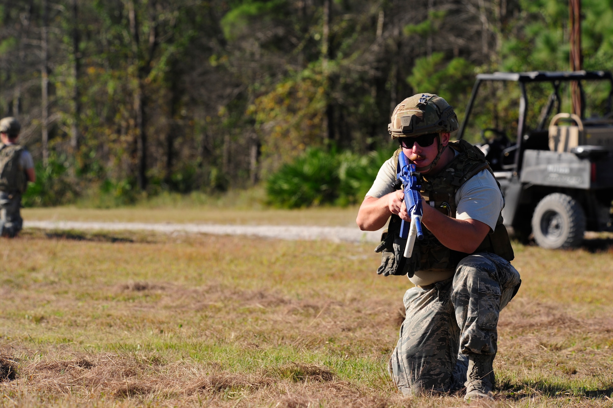 Senior Airman Kyle Fletcher, 823rd REDHORSE Squadron Detachment 1 Silver Flag student and Explosive Ordinance Disposal technician, covers his squadron teammates Oct. 22 as they prep a simulated charge to dispose of unexploded ordinance. The Silver Flag site is also home to EOD's Combat Battlefield Ready Airmen course.  Deploying teams are scheduled for training according to the unit and location they are tasked. This pre-deployment course provides training to all Air Force EOD personnel deploying into the Allied Forces Central European Theater. EOD students receive three weeks of extensive training that permits them to work together prior to deployment. Training covers all technical and tactical aspects of EOD operations in the AFCENT theater environment. This vital training combines lessons previously taught at Army Combat Skills Training and the Global Antiterrorism and Operational Readiness courses. (U.S. Air Force photo by Senior Airman Solomon Cook/Released)