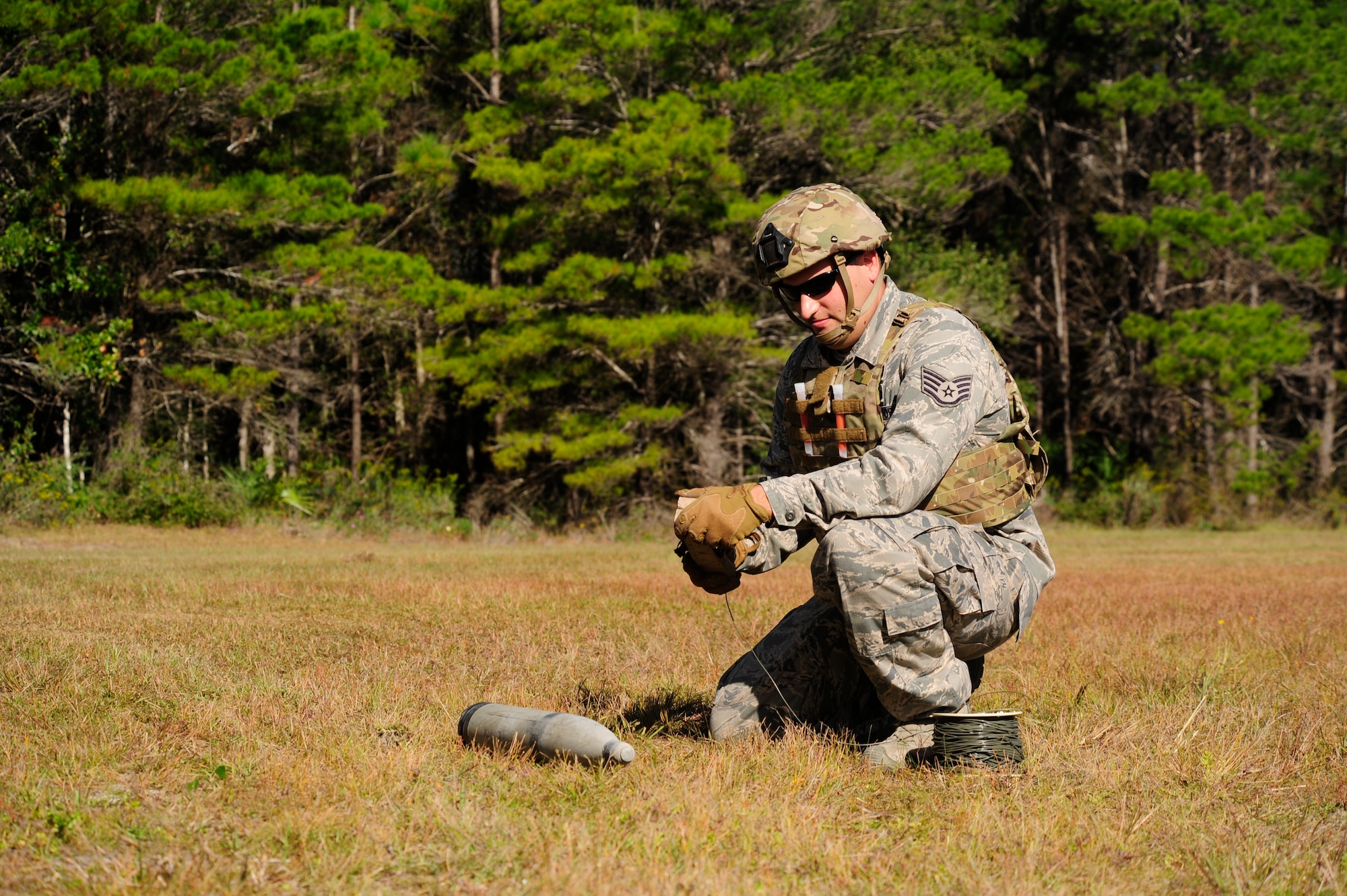 Staff Sgt. Mike Stuenzi, 823rd REDHORSE Squadron Detachment 1 Silver Flag student and Explosive Ordinance Disposal technician, preps simulated charge to dispose of unexploded ordinance Oct. 22 at Location X. The Silver Flag site is also home to EOD's Combat Battlefield Ready Airmen course.  Deploying teams are scheduled for training according to the unit and location they are tasked. This pre-deployment course provides training to all Air Force EOD personnel deploying into the Allied Forces Central European Theater. EOD students receive three weeks of extensive training that permits them to work together prior to deployment. Training covers all technical and tactical aspects of EOD operations in the AFCENT theater environment. This vital training combines lessons previously taught at Army Combat Skills Training and the Global Antiterrorism and Operational Readiness courses. (U.S. Air Force photo by Senior Airman Solomon Cook/Released)