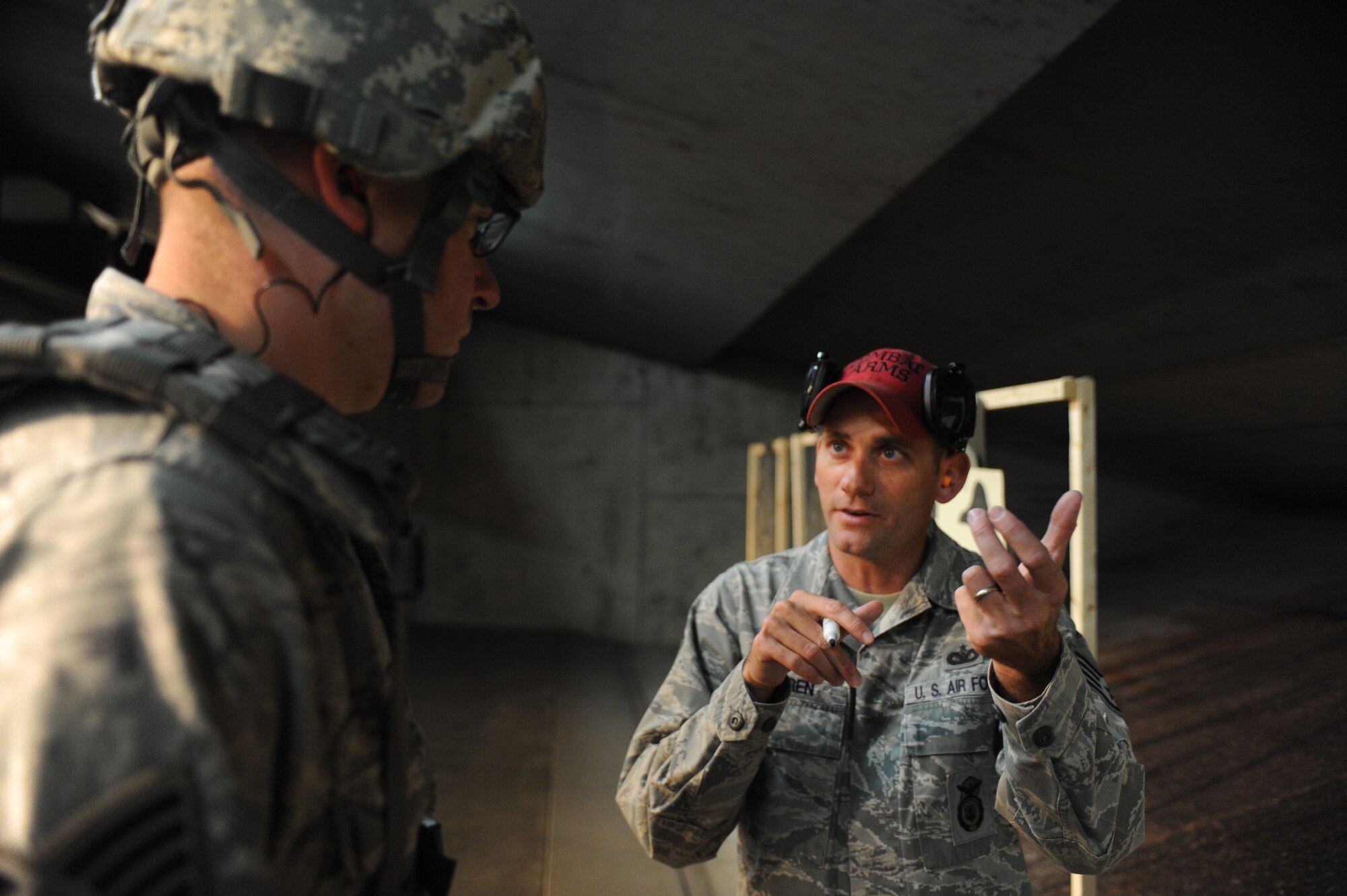 Staff Sgt. Nathan Warren, 28th Security Forces Squadron combat arms instructor, reviews proper firing techniques with Master Sgt. Peter Holtz, 28th SFS flight chief, at Ellsworth Air Force Base, S.D., Oct. 13, 2015. Prior to practical application on the range, students learn about firing stances, troubleshooting malfunctions and weapon maintenance. (U.S. Air Force photo by Airman Sadie Colbert/Released)