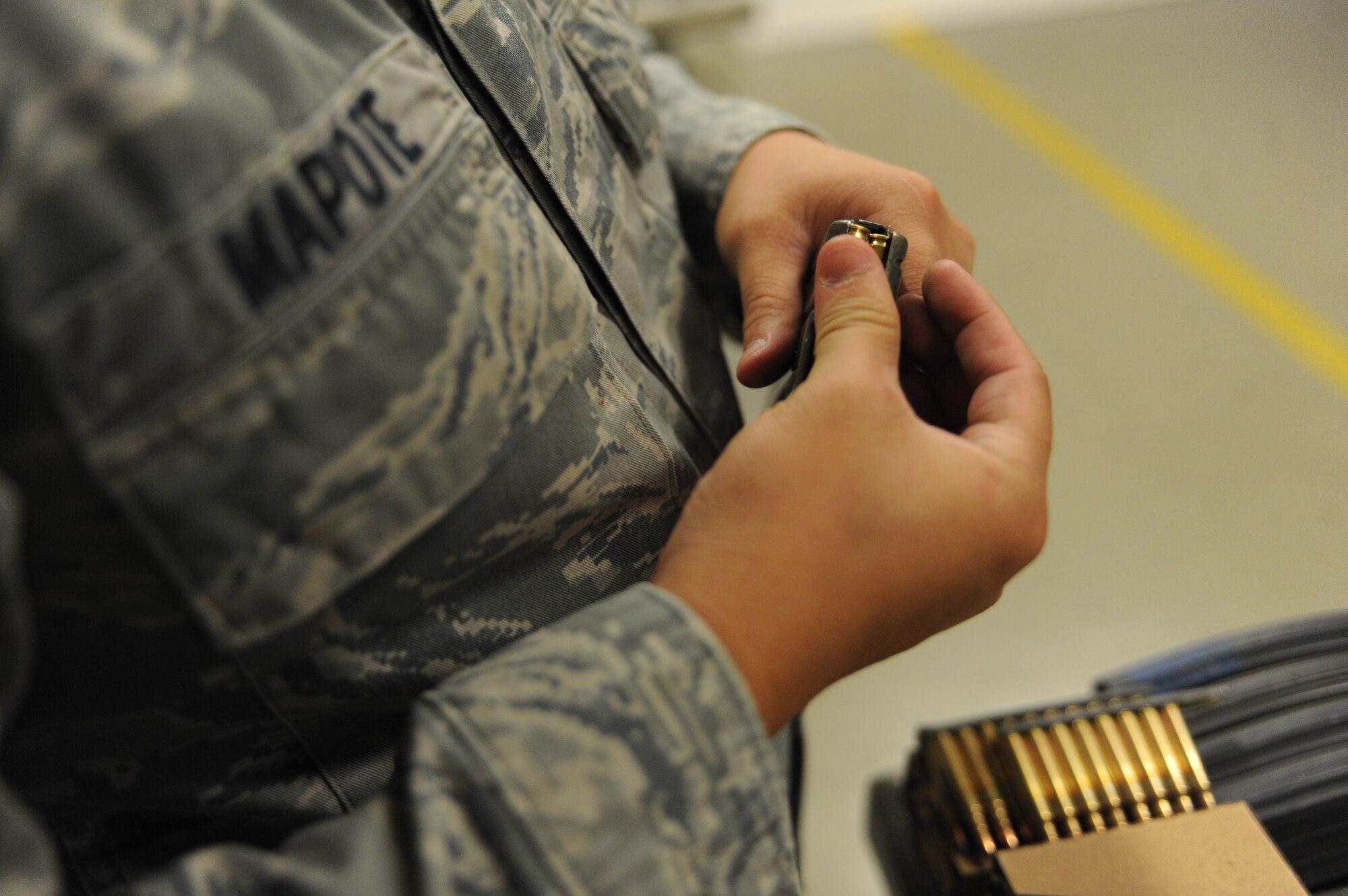 Senior Airman BobbyLee Mapote, 28th Security Forces Squadron response force leader, loads an M9 pistol round into a magazine prior to weapons training at Ellsworth Air Force Base, S.D., Oct. 13, 2015. Ellsworth’s combat arms training includes instruction on different types of ammunitions and how to load magazines. (U.S. Air Force photo by Airman Sadie Colbert/Released)