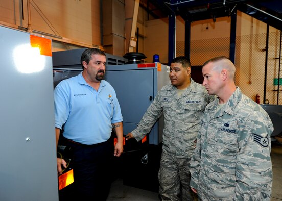 Rick Hammock, 97th Maintenance Squadron aerospace ground equipment work leader from Altus Air Force Base, Okla., examines a mobile power generator for the KC-46A Pegasus with Staff Sgt. Detreck Ortiz, middle, 22nd MXS aerospace ground equipment journeyman, and Staff Sgt. Allan Shurtz, 931st MXS aerospace ground equipment journeyman, Oct. 27, 2015, at McConnell Air Force Base, Kan. Personnel from the three maintenance squadrons are working with the 22nd Logistics Readiness Squadron as maintenance equipment is shipped to McConnell in preparation of the arrival of the KC-46. (U.S. Air Force photo/Senior Airman Victor J. Caputo)