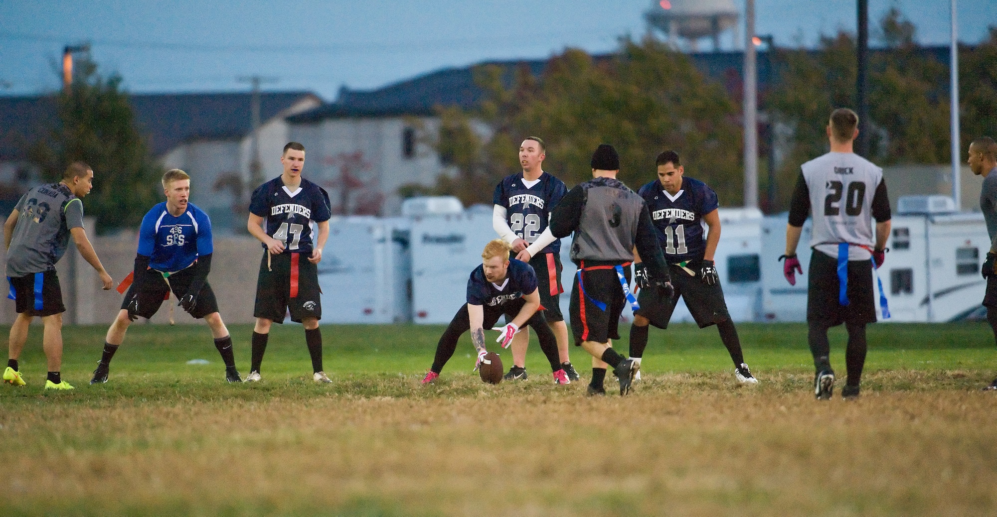 Adam Paini, 436th Security Forces Squadron quarterback, looks over the 436th Logistics Readiness Squadron defensive formation during an intramural flag football game Oct. 26, 2015, on Dover Air Force Base, Del. The offense and defense of the 436th LRS proved too much for the 436th SFS Defenders, losing 35-15. (U.S. Air Force photo/Roland Balik)
