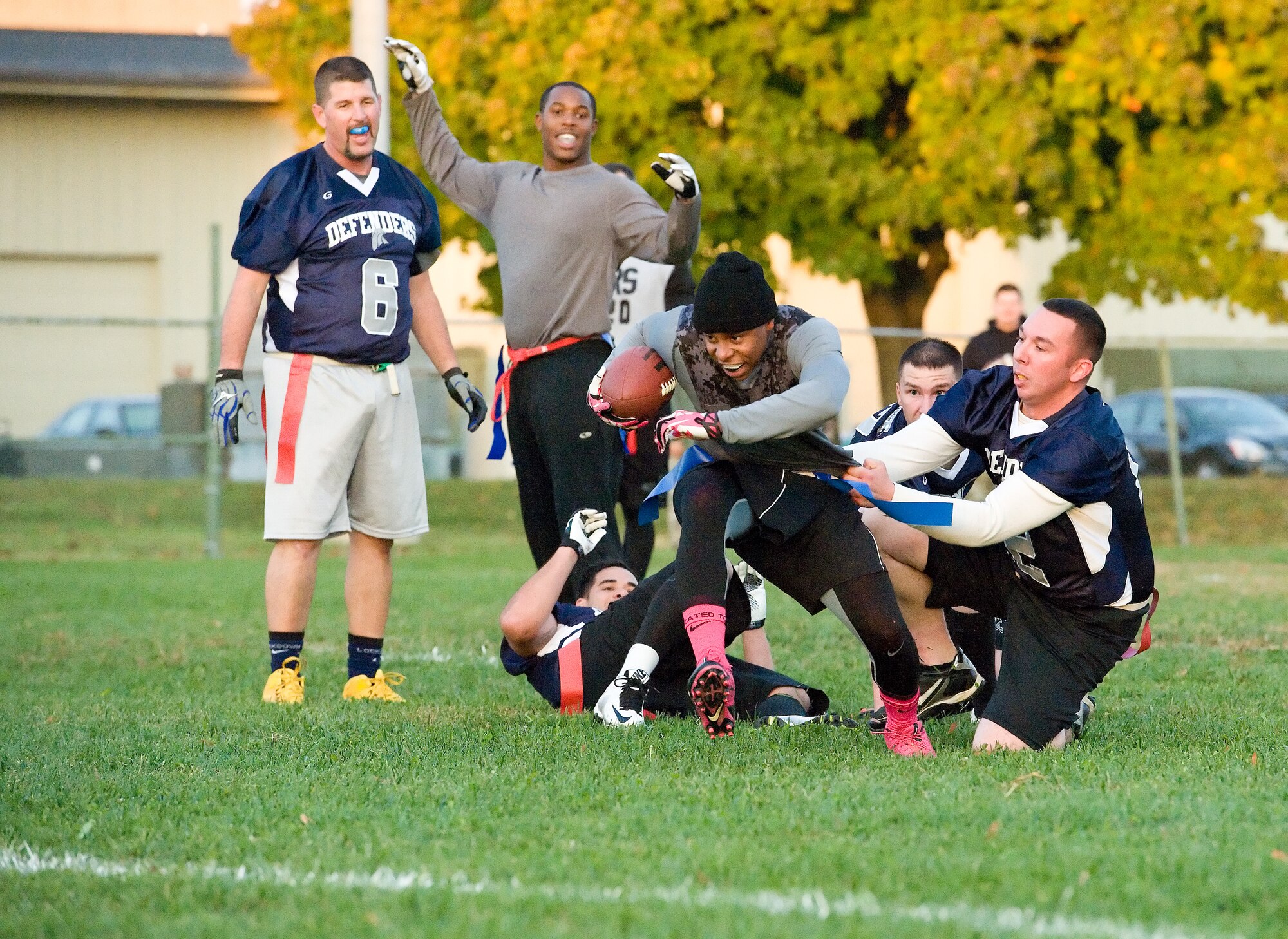Travis Cabb, 436th Logistics Readiness Squadron running back, tries to run away from the grasp of Adam Paini, 436th Security Forces Squadron defensive lineman Oct. 26, 2015, on Dover Air Force Base, Del. Cabb's running efforts wore down the 436th SFS defense. (U.S. Air Force photo/Roland Balik)