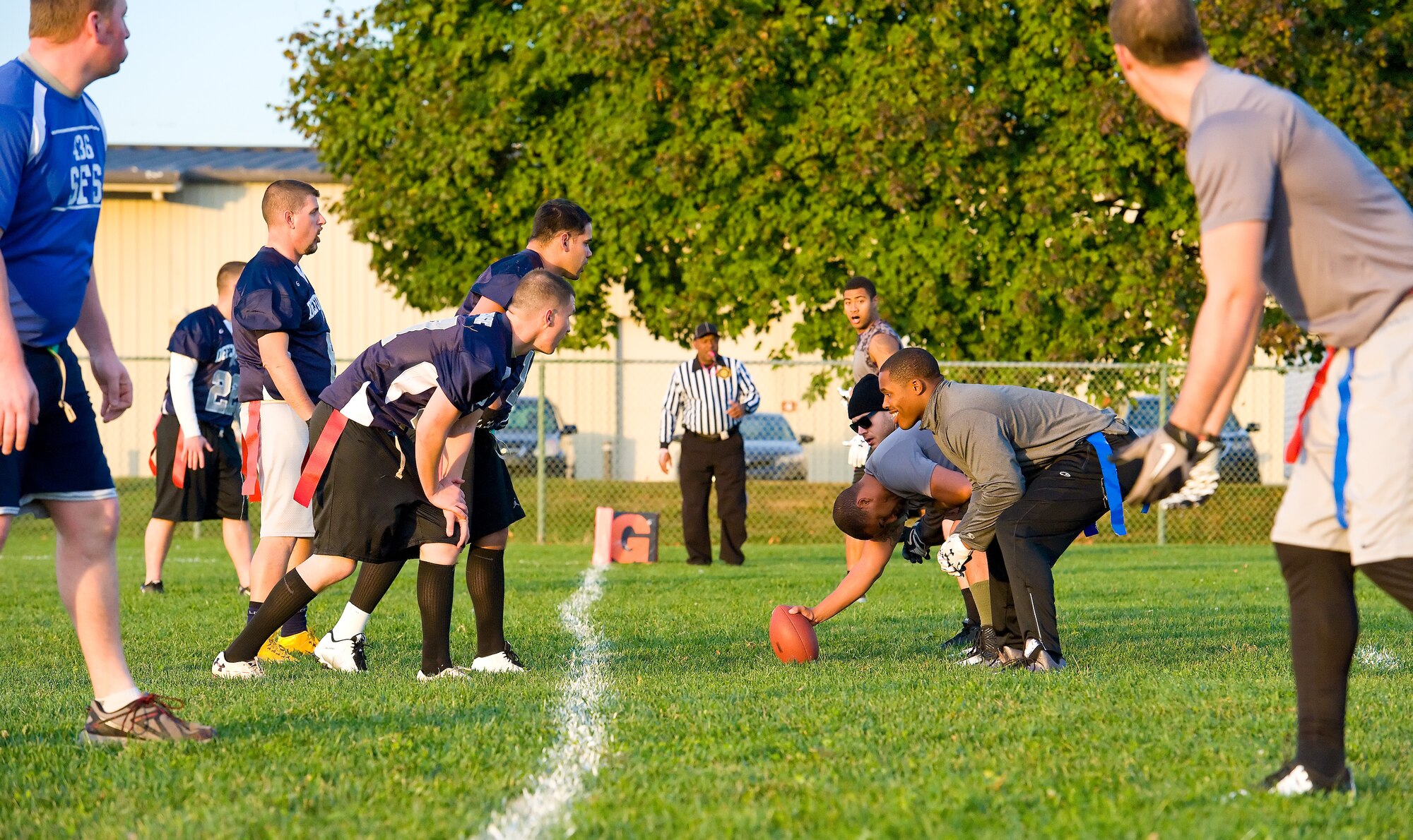Kevin Fowler, 436th Logistics Readiness Squadron center, waits to hike the football to quarterback Joshua Orick Oct. 26, 2015, on Dover Air Force Base, Del. The 436th LRS played 436th Security Forces Squadron in an intramural flag football game for the third time this season. (U.S. Air Force photo/Roland Balik)