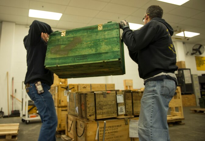 (From left to right) Naval Munitions Command Atlantic Unit Charleston work leaders, Bryan Shaw and Mark Lamoureux, stack a crate of equipment to complete a pallet on Oct. 27, 2015, at Joint Base Charleston – Naval Weapons Station. The pallet is one of several that will be included in a much larger storage container to be loaded on the United States Naval Ship Red Cloud.