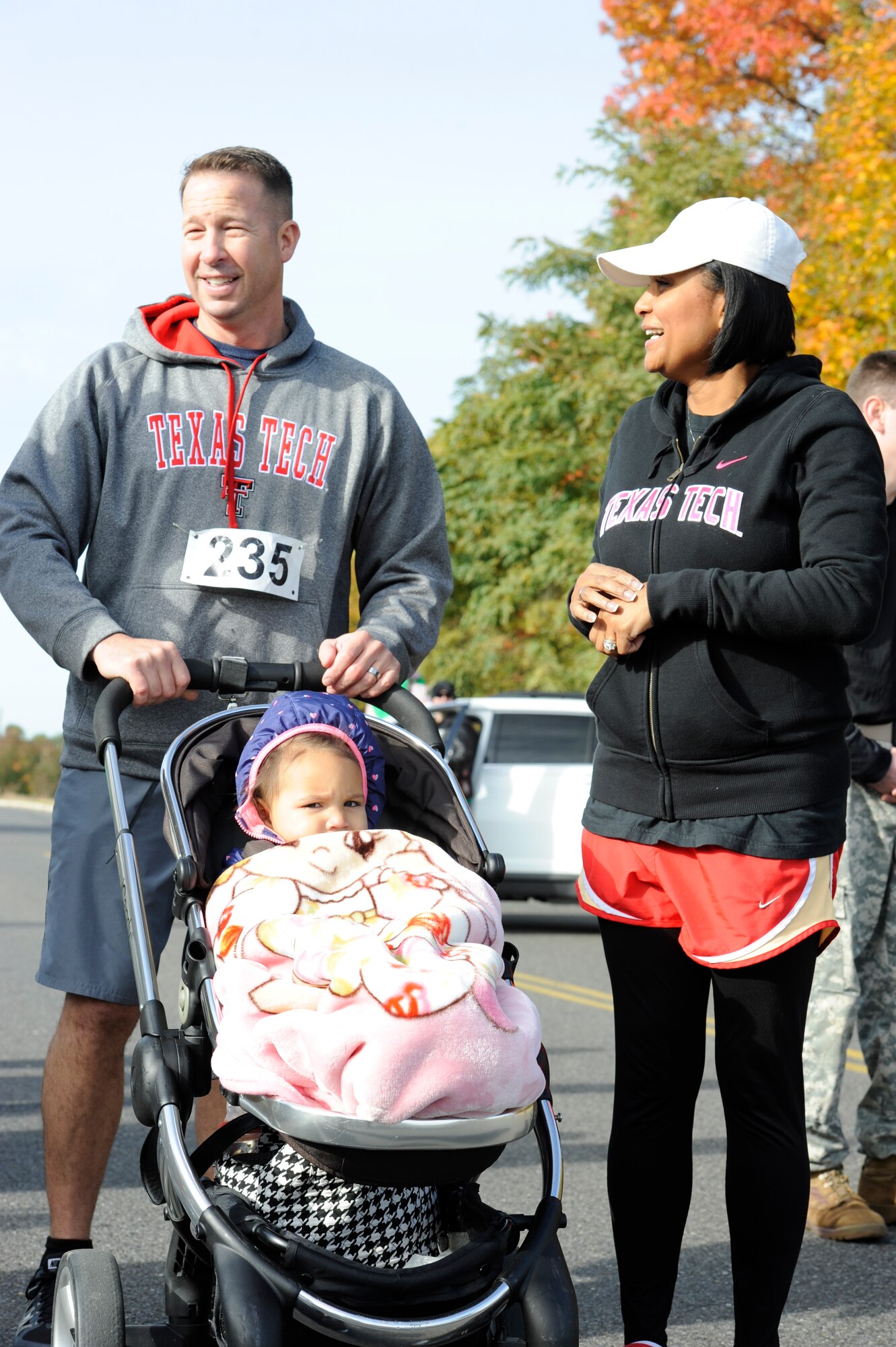 Master Sgt. Adam Clingan, 87 Logistics Readiness Squadron Petroleum Oil and Lubricants fiscal section chief, prepares to run with his daughter Oct. 24, 2015, at Joint Base McGuire-Dix-Lakehurst, N.J. Clingan marched in the ninth annual Gold Star Ruck March to raise awareness for the foundation. (U.S. Air Force photo by Senior Airman Sean M. Crowe/Released)