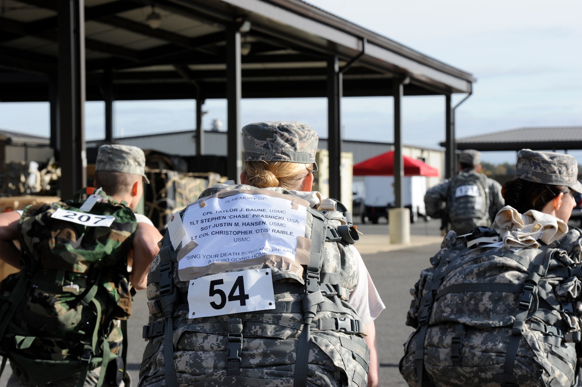 Staff Sgt. Caitlin Jones, Joint Base McGuire-Dix-Lakehurst Public Affairs broadcaster, marches with a list names in which she is commemorating in the ninth annual Gold Star Ruck March Oct. 24, 2015, at Joint Base McGuire-Dix-Lakehurst, N.J. The event is a fundraiser for Gold Star Moms, a charitable organization which supports family members who have lost a loved one in the line of military service. (U.S. Air Force photo by Senior Airman Sean M. Crowe/Released)