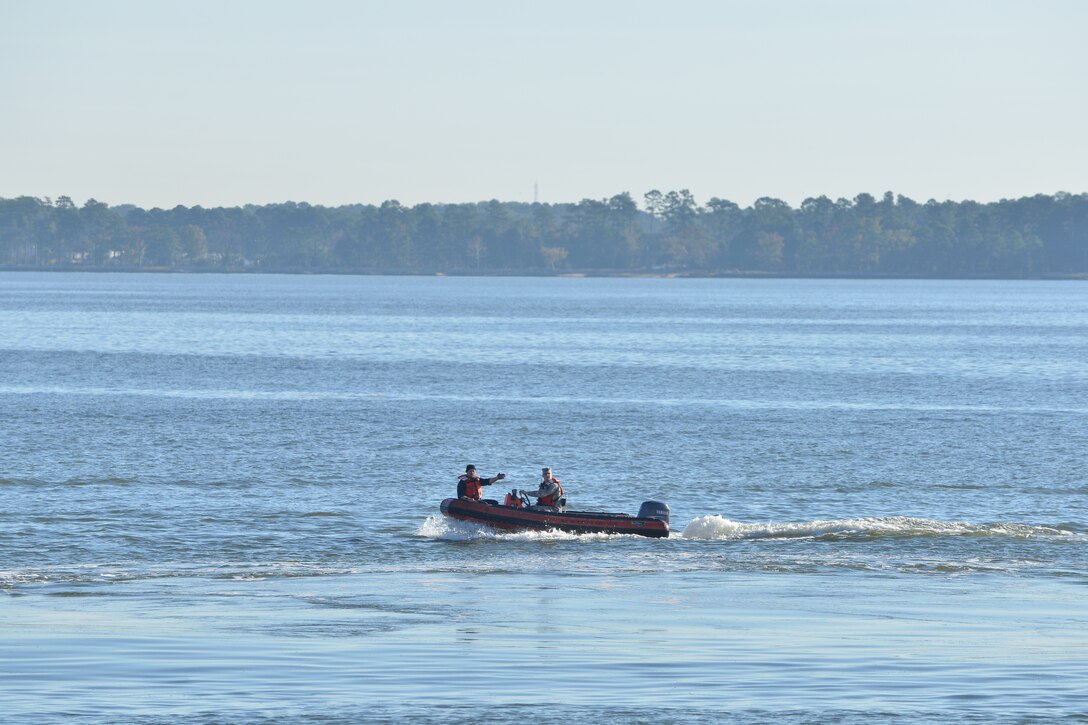 Members of the 73rd Transportation Company U.S. Army tugboat MG Winfield Scott survey a training area during a joint casualty evacuation exercise involving the Scott crewmembers and the U.S. Coast Guard at Fort Eustis, Va., Oct. 21, 2015. The surveyors watched for hazards in the area, and stood by to provide rescue support if anyone sustained real injuries during the exercise. (U.S. Air Force photo by Staff Sgt. Natasha Stannard/Released)