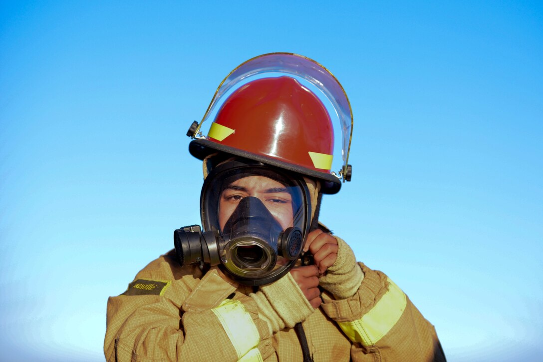 U.S. Army Spc. Inderjeet Khagura, 73rd Transportation Company watercraft operator, dons firefighter gear aboard the U.S. Army tugboat MG Winfield Scott at Fort Eustis, Va., Oct. 21, 2015. The Scott’s crew conducts firefighter training along with other emergency procedures weekly to maintain lifesaving proficiency. (U.S. Air Force photo by Staff Sgt. Natasha Stannard/Released)
