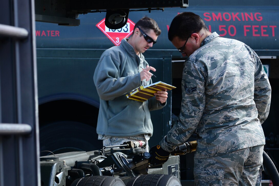 U.S. Air Force Senior Airman, Travis Grohman, 633rd Logistics Readiness Squadron fuels distributor, evaluates Airman 1st Class Joseph Quiros, 633rd LRS air transportation apprentice, as he fuels a K-Loader at Langley Air Force Base, Va., Oct. 19, 2015. In addition to fueling K-Loaders, the Airmen fuel forklifts, tugs, generators and aircraft at Langley.  (U.S. Air Force photo by Senior Airman Kimberly Nagle/ Released)