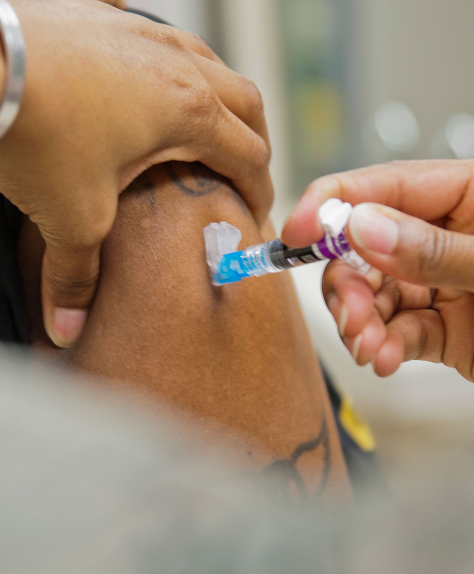 A family member receives a flu shot at the immunizations clinic on Joint Base Elmendorf-Richardson, Alaska, Oct. 14, 2015. The immunization clinic is open from 7:30 to 11:30 a.m. and 12:30 to 4:15 p.m., Monday through Friday for flu shots and flu sprays. Shots for family members and retirees will be available Nov. 1. For more information about colds, the flu or any other seasonal diseases, visit www.cdc.gov or the 673d MDG immunization clinic at 580-2002. (U.S. Air Force photo/Senior Airman Tammie Ramsouer)