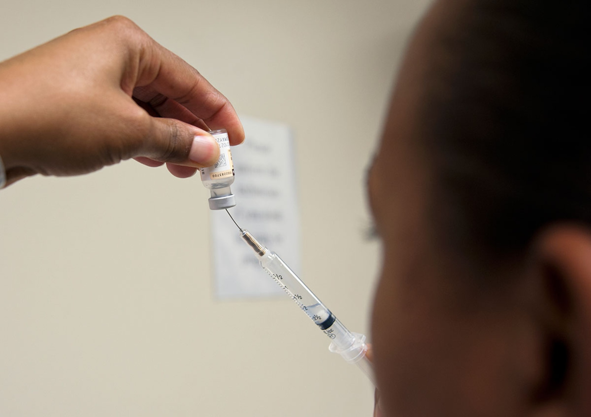 Senior Airman Natasha Mullins, 673d Women’s Health Clinic medic, prepares a syringe for a flu shot at the immunization clinic on Joint Base Elmendorf-Richardson, Alaska, Oct. 14, 2015. An active influenza shot or inactive influenza nasal spray are the best ways to prevent contracting the flu. (U.S. Air Force photo/Senior Airman Tammie Ramsouer)