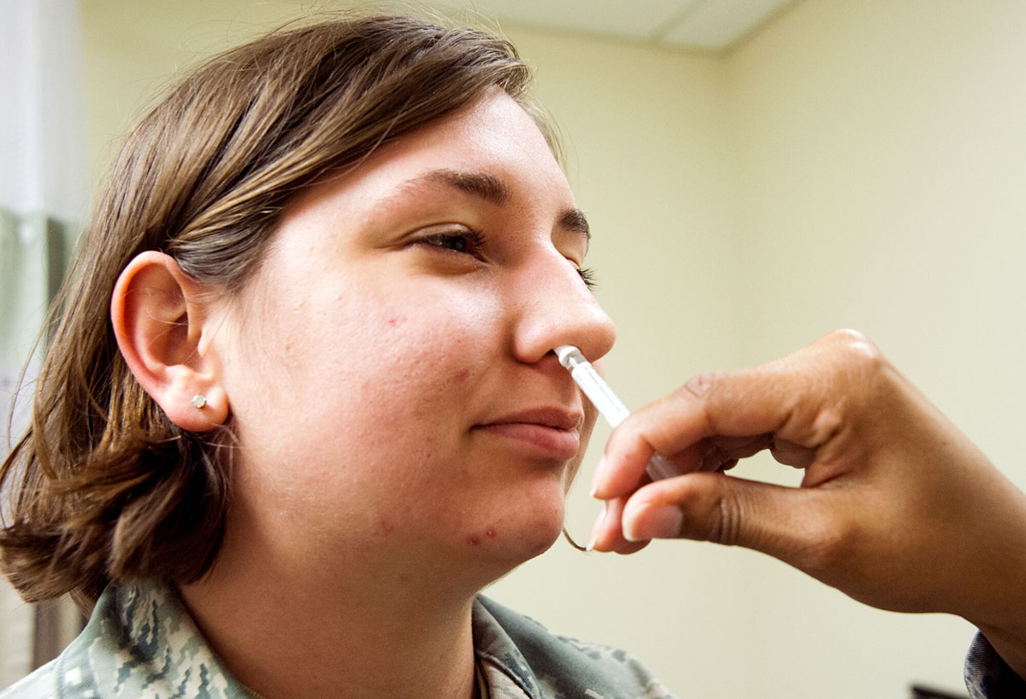 Senior Airman Taylor Vanderveen, 673d Communications Squadron radio frequency transmission technician, receives the flu mist at the immunization clinic on Joint Base Elmendorf-Richardson, Alaska, Oct. 14, 2015. The spray can be given to patients between the ages of 2 to 49. Those who receive the flu mist can sometimes experience cold-like symptoms. (U.S. Air Force photo/Senior Airman Tammie Ramsouer)