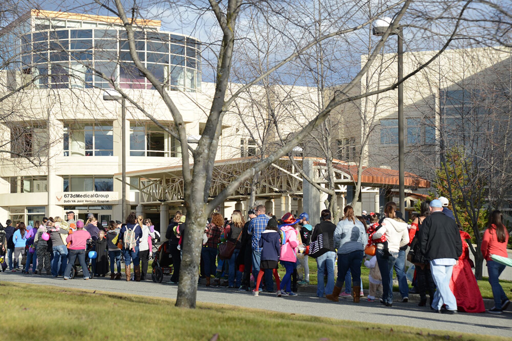 Families queue up for the Trick-or-Treat event at the hospital on Joint Base Elmendorf-Richardson, Alaska, Oct. 23, 2015. Many hospital workers dressed according to a theme within their respective clinics and handed candy to people of all ages during the annual event. This event allows children to associate hospitals with more than just flu shots and medicine, but friendly fun as well. (U.S. Air Force photo/Airman 1st Class Christopher R. Morales)