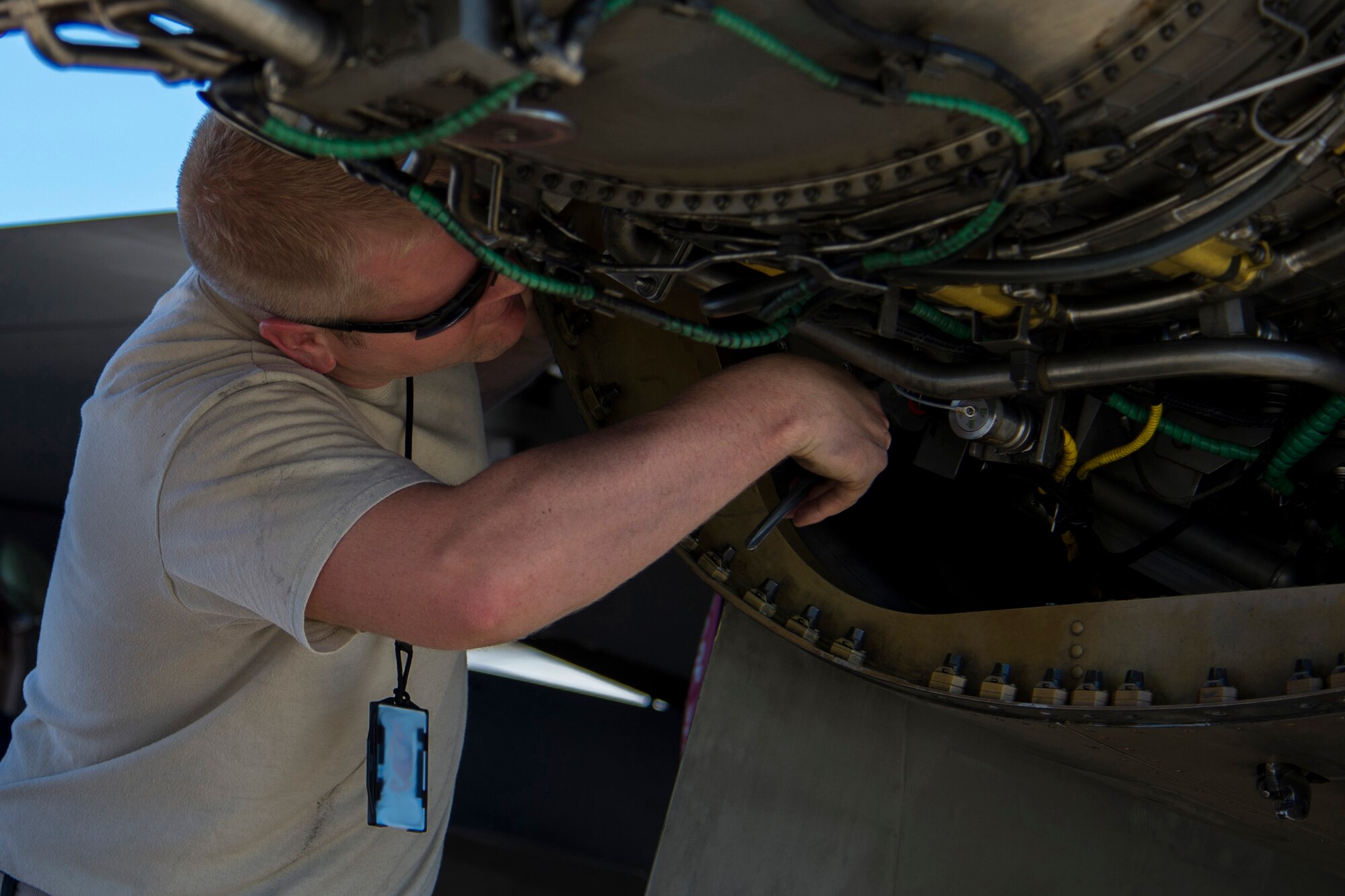 BEJA AIR BASE, Portugal – U.S. Air Force Staff Sgt. Christopher Lancaster, 52nd Component Maintenance Squadron aerospace propulsion technician, works on the engine of an F-16 Fighting Falcon fighter aircraft, assigned to the 480th Fighter Squadron at Spangdahlem Air Base, Germany, before it participates in Trident Juncture 2015 at Beja Air Base, Portugal, Oct. 22, 2015. NATO exercises such as Trident Juncture provide an excellent venue for current and hopeful NATO members to work on their warfighting, communication and coordination skills. (U.S. Air Force photo illustration by Airman 1st Class Luke Kitterman/Released)