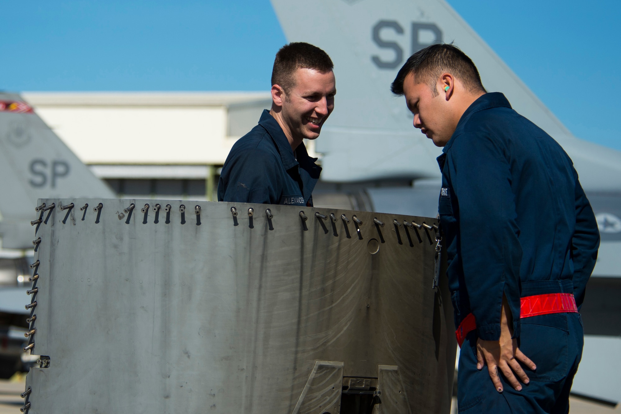 BEJA AIR BASE, Portugal – U.S. Air Force Staff Sgt. Derek Alexander, 52nd Aircraft Maintenance Squadron crew chief, left, and U.S. Air Force Staff Sgt. Ramon Salas, 52nd AMXS electrical and environmental systems craftsman, remove an engine panel from a 480th Fighter Squadron F-16 Fighting Falcon fighter aircraft at Beja Air Base, Portugal, Oct. 22, 2015. U.S. participation in Trident Juncture 2015l includes Army, Air Force, Navy, Marine Corps and special operations assets, to include some Army National Guard and Air National Guard assets.  (U.S. Air Force photo by Airman 1st Class Luke Kitterman/Released)