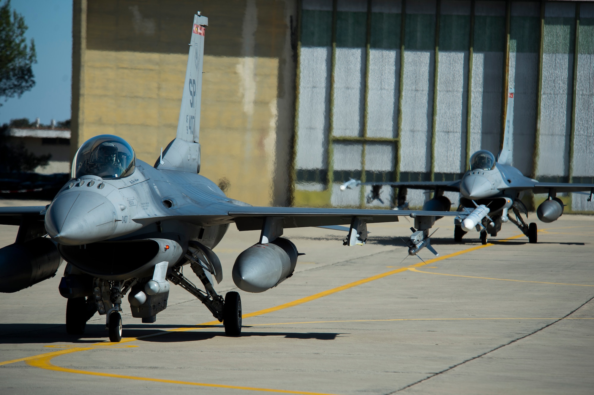 BEJA AIR BASE, Portugal – Two F-16 Fighting Falcon fighter aircraft, assigned to the 480th Fighter Squadron at Spangdahlem Air Base, Germany, taxi towards the runway before a mission at Exercise Trident Juncture 2015 at Beja Air Base, Portugal, Oct. 22, 2015. The 480th FS deployed five F-16s and approximately 130 Airmen to Beja in support of Trident Juncture 2015, the largest NATO exercise conducted in the past 20 years. (U.S. Air Force photo by Airman 1st Class Luke Kitterman/Released)  