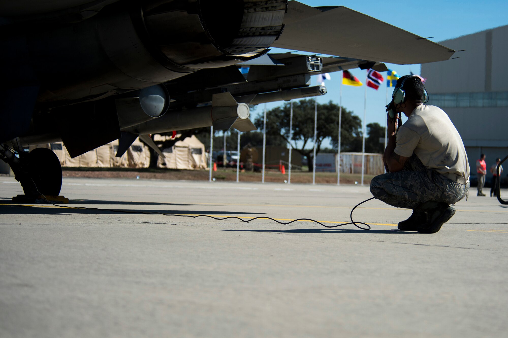 BEJA AIR BASE, Portugal – U.S. Air Force Staff Sgt. Christopher Pridgen, 52nd Aircraft Maintenance Squadron crew chief, conducts a pre-flight check on an F-16 Fighting Falcon fighter aircraft, assigned to the 480th Fighter Squadron at Spangdahlem Air Base, Germany, before it participates in Trident Juncture 2015 at Beja Air Base, Portugal, Oct. 22, 2015. More than 100 Airmen assigned to the 52nd Maintenance Group deployed to Portugal in support of Trident Juncture 2015, the largest NATO exercise conducted in the past 20 years. (U.S. Air Force photo illustration by Airman 1st Class Luke Kitterman/Released)