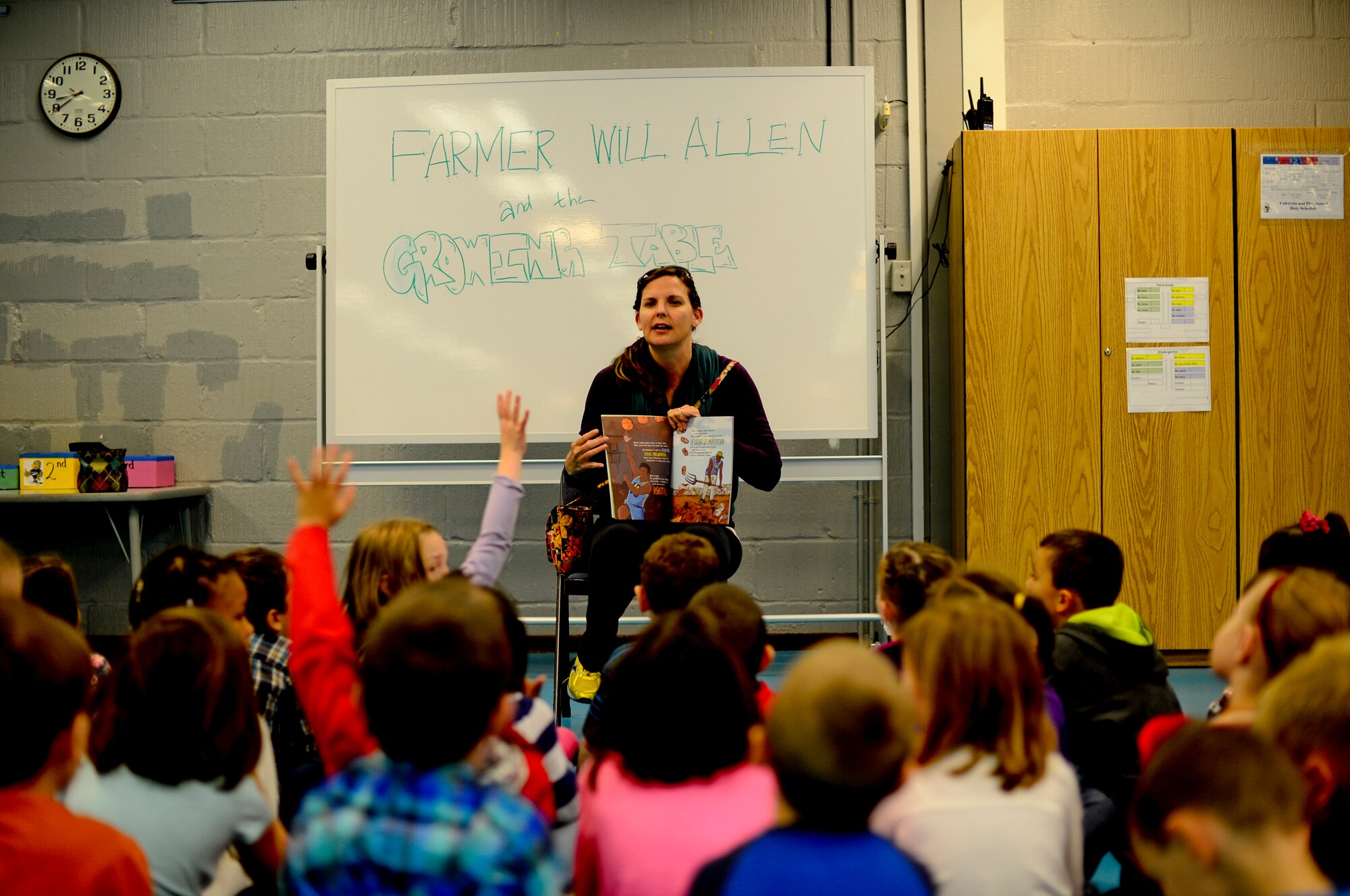 A volunteer reads to children during a worldwide event known as Read Across the Globe, at Royal Air Force Lakenheath Elementary School, England, Oct. 20, 2015. The event was organized to promote literacy amongst school-aged children, with a goal to read to 238,000 children over a 24-hour period in order to qualify for a spot in the Guinness Book of World Records. (U.S. Air Force photo by Senior Airman Erin O’Shea/Released) 