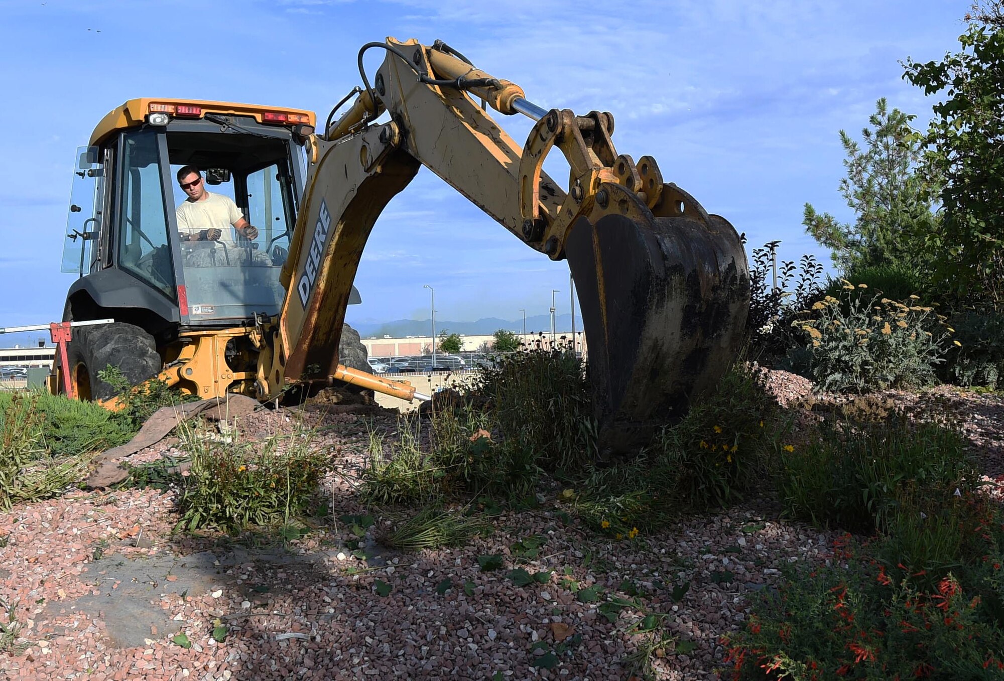 A 460th Civil Engineer Squadron member works on repairing a gas leak outside of Panther Den Aug. 7, 2015, on Buckley Air Force Base, Colo. The gas leak caused a temporary re-route of traffic on Aspen Road between Devils Thumb Avenue and Keystone Avenue and closed Panther Den for part of the day. (U.S. Air Force photo by Airman 1st Class Samantha Meadors/Released)