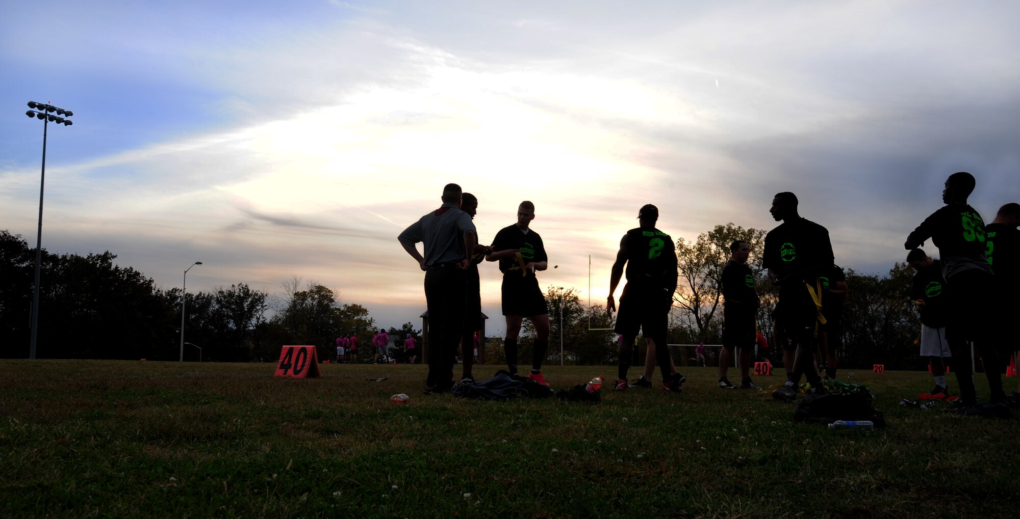 Members of the 509th Security Forces Squadron (SFS) put on their belts before the start of the intramural flag-football championship game at Whiteman Air Force Base, Mo., Oct. 26, 2015. The 509th SFS faced off against the 509th Operations Support Squadron (OSS). The 509th SFS would go on to defeat the 509th OSS with a score of 32-24. (U.S. Air Force photo by Senior Airman Joel Pfiester/Released)
