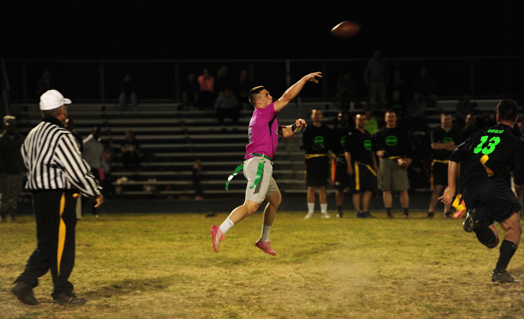 Senior Airman Fontaine Richardson, 509th Operations Support Squadron (OSS) air traffic controller, throws to his wide receiver during the intramural flag-football championship game at Whiteman Air Force Base, Mo., Oct 26, 2015. Out of 11 teams, the 509th Security Forces Squadron and 509th OSS played in the final championship game. (U.S. Air Force photo by Senior Airman Joel Pfiester/Released)