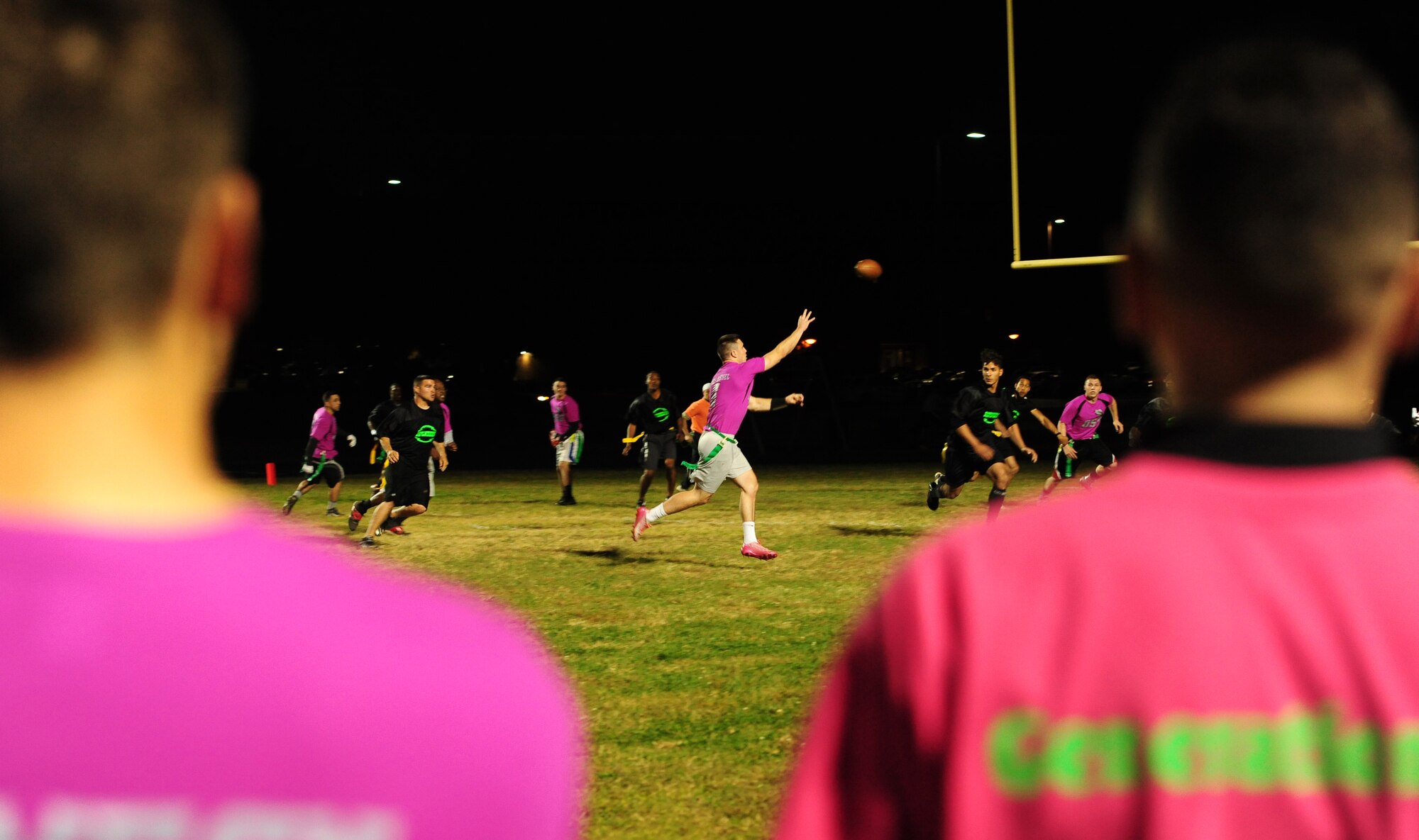 Senior Airman Fontaine Richardson, 509th Operations Support Squadron air traffic controller, passes to his wide receiver during the intramural flag-football championship game at Whiteman Air Force Base, Mo., Oct 26, 2015. The 509th SFS would go on to defeat the 509th OSS with a score of 32-24. (U.S. Air Force photo by Senior Airman Joel Pfiester/Released)
