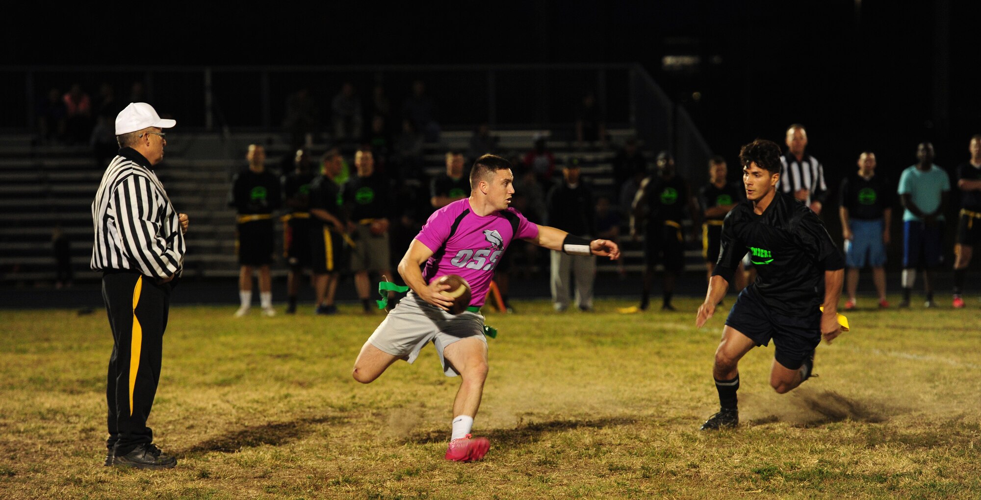 Senior Airman Fontaine Richardson, 509th Operations Support Squadron (OSS) air traffic controller, scrambles away from a defender during the intramural flag-football championship game at Whiteman Air Force Base, Mo., Oct. 26, 2015. The 509th Security Forces Squadron defeated the 509th OSS with a score of 32-24. (U.S. Air Force photo by Senior Airman Joel Pfiester/Released)

