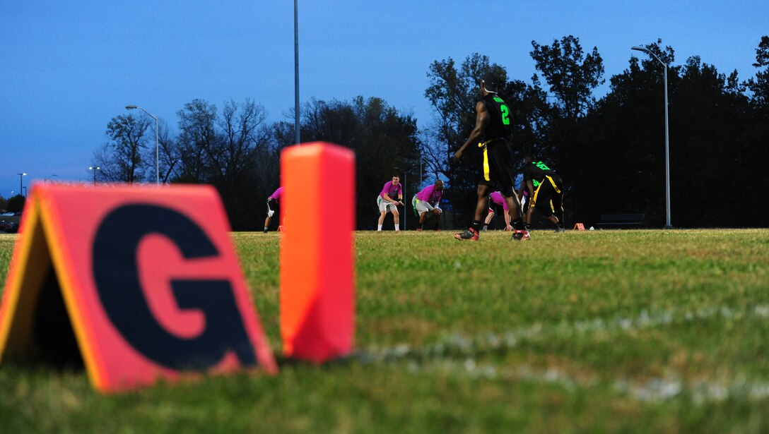 Members of the 509th Operations Support Squadron (OSS) prepare to snap the ball during the intramural flag-football championship game at Whiteman Air Force Base, Mo., Oct. 26, 2015. The 509th OSS faced off against the 509th Security Forces Squadron (SFS). The 509th SFS would go on to defeat the 509th OSS with a score of 32-24. (U.S. Air Force photo by Senior Airman Joel Pfiester/Released)

