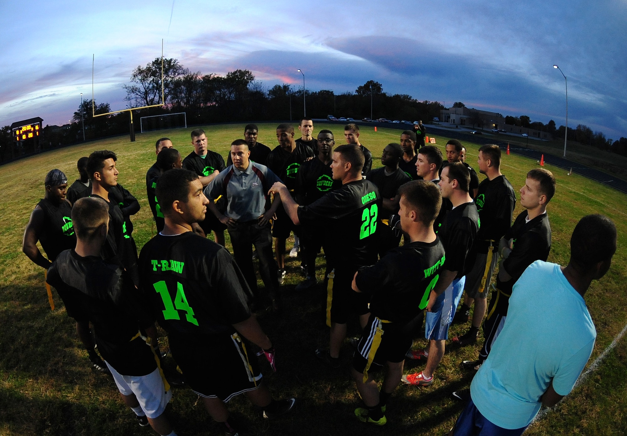 Members of the 509th Security Forces Squadron (SFS) huddle during halftime of the intramural flag-football championship game at Whiteman Air Force Base, Mo., Oct 26, 2015. At halftime, the 509th SFS was leading with a score of 16-8. The 509th SFS would go on to defeat the 509th Operations Support Squadron with a score of 32-24. (U.S. Air Force photo by Senior Airman Joel Pfiester/Released)