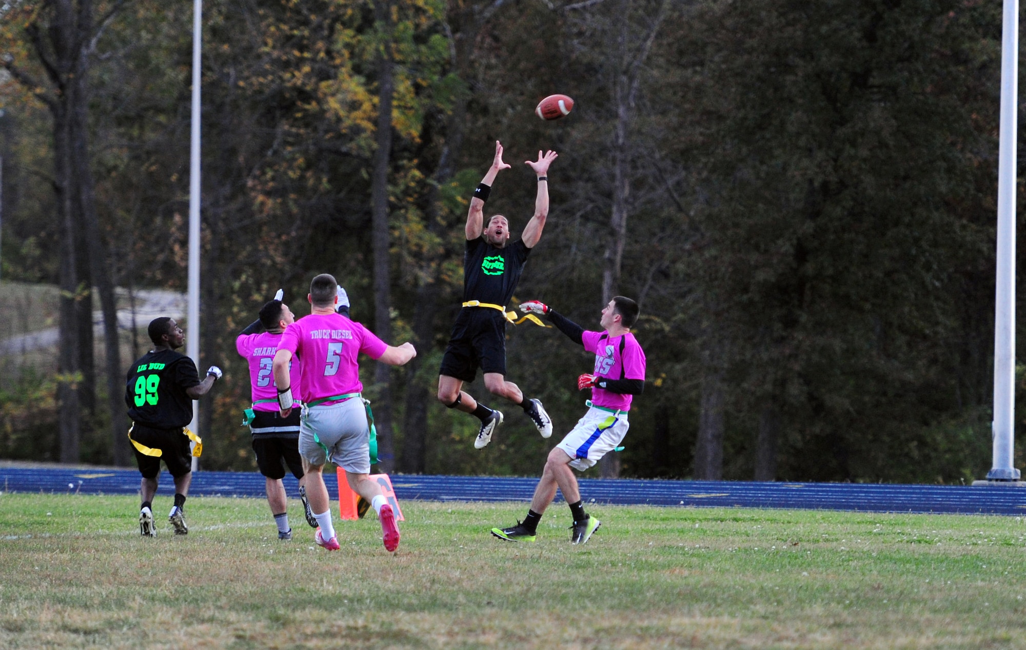 Airman 1st Class Phillippe Moore, 509th Security Forces Squadron (SFS) security response team member, jumps to make a catch during the intramural flag-football championship game at Whiteman Air Force Base, Mo., Oct. 26, 2015. The 509th SFS faced off against the 509th Operations Support Squadron (OSS). The 509th SFS would go on to defeat the 509th OSS with a score of 32-24. (U.S. Air Force photo by Senior Airman Joel Pfiester/Released)