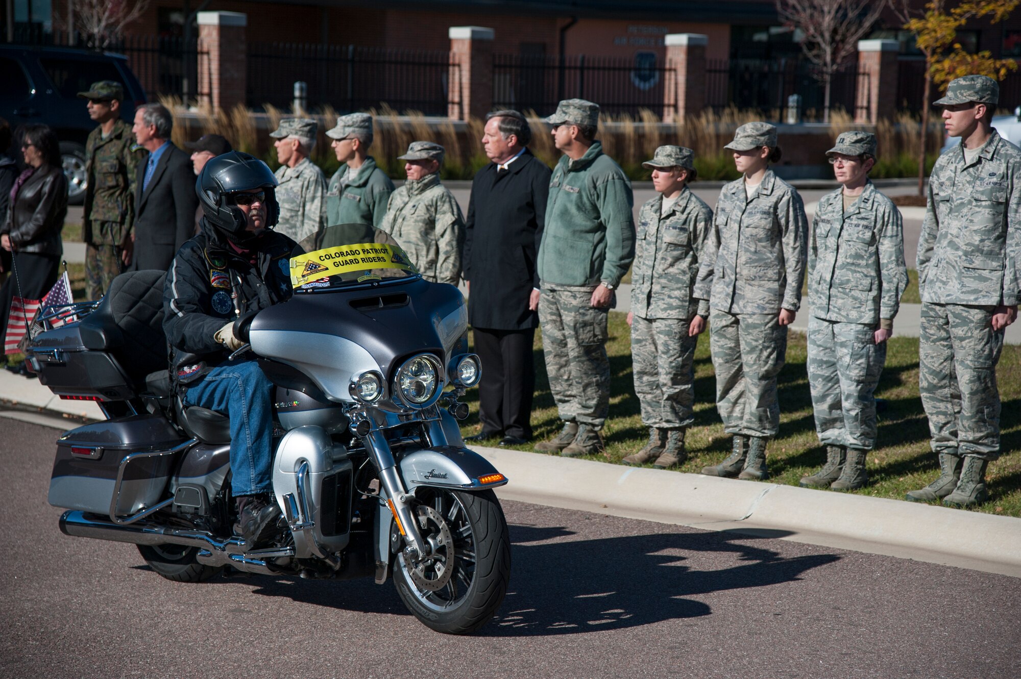 PETERSON AIR FORCE BASE, Colo. - Service members and family line the streets at Peterson Air Force Base during a dignified transfer ceremony for Maj. Phyllis Pelky on Oct. 23, 2015. Pelky was deployed from the U.S. Air Force Academy and was killed in a helicopter accident Oct. 11, 2015 in Kabul, Afghanistan. (U.S.Air Force photo by Senior Airman Tiffany DeNault)