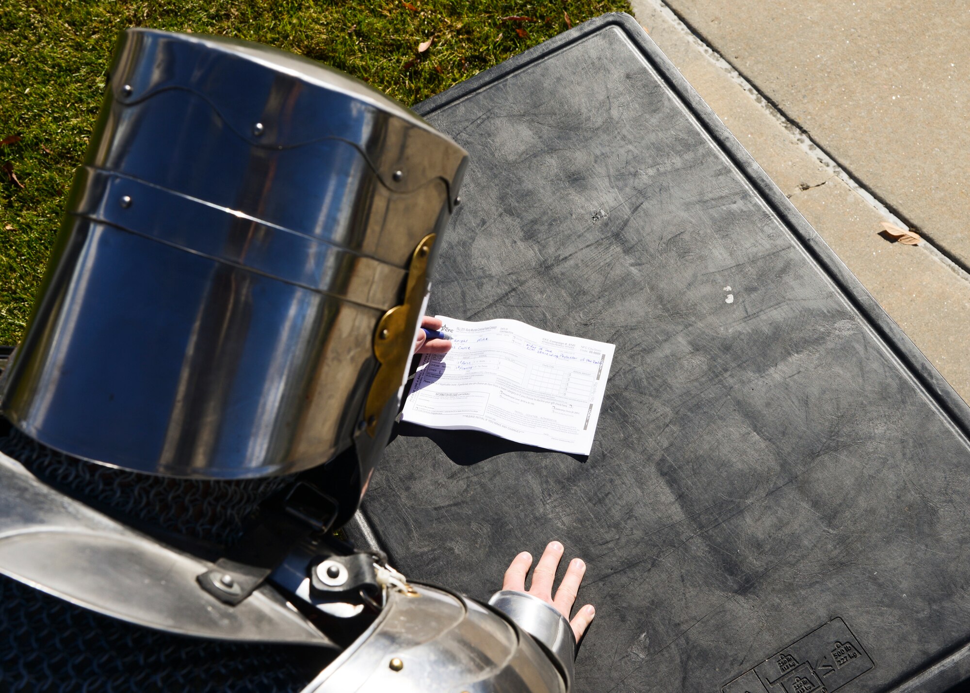 PETERSON AIR FORCE BASE, Colo. – Peterson’s own Mike the Knight completes his Combined Federal Campaign donation form Oct. 27, 2015. CFC officially kicked off Oct. 1 and will run through Dec. 15. For information on how to donate, contact your unit representative. (U.S. Air Force photo by Tech. Sgt. Jared Marquis)
