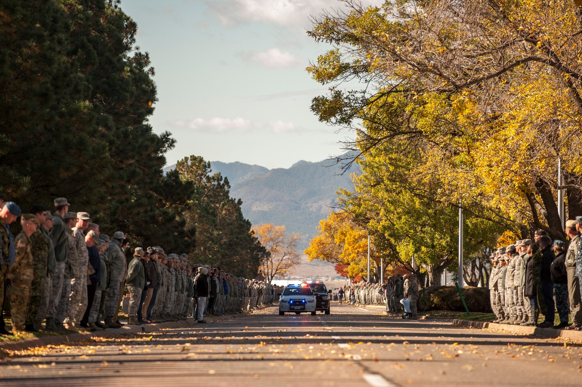 PETERSON AIR FORCE BASE, Colo. - Service members and family line the streets at Peterson Air Force Base during a dignified transfer ceremony for Maj. Phyllis Pelky on Oct. 23, 2015. Pelky was deployed from the U.S. Air Force Academy and was killed in a helicopter accident Oct. 11, 2015 in Kabul, Afghanistan. (U.S. Air Force photo by Senior Airman Rose Gudex)