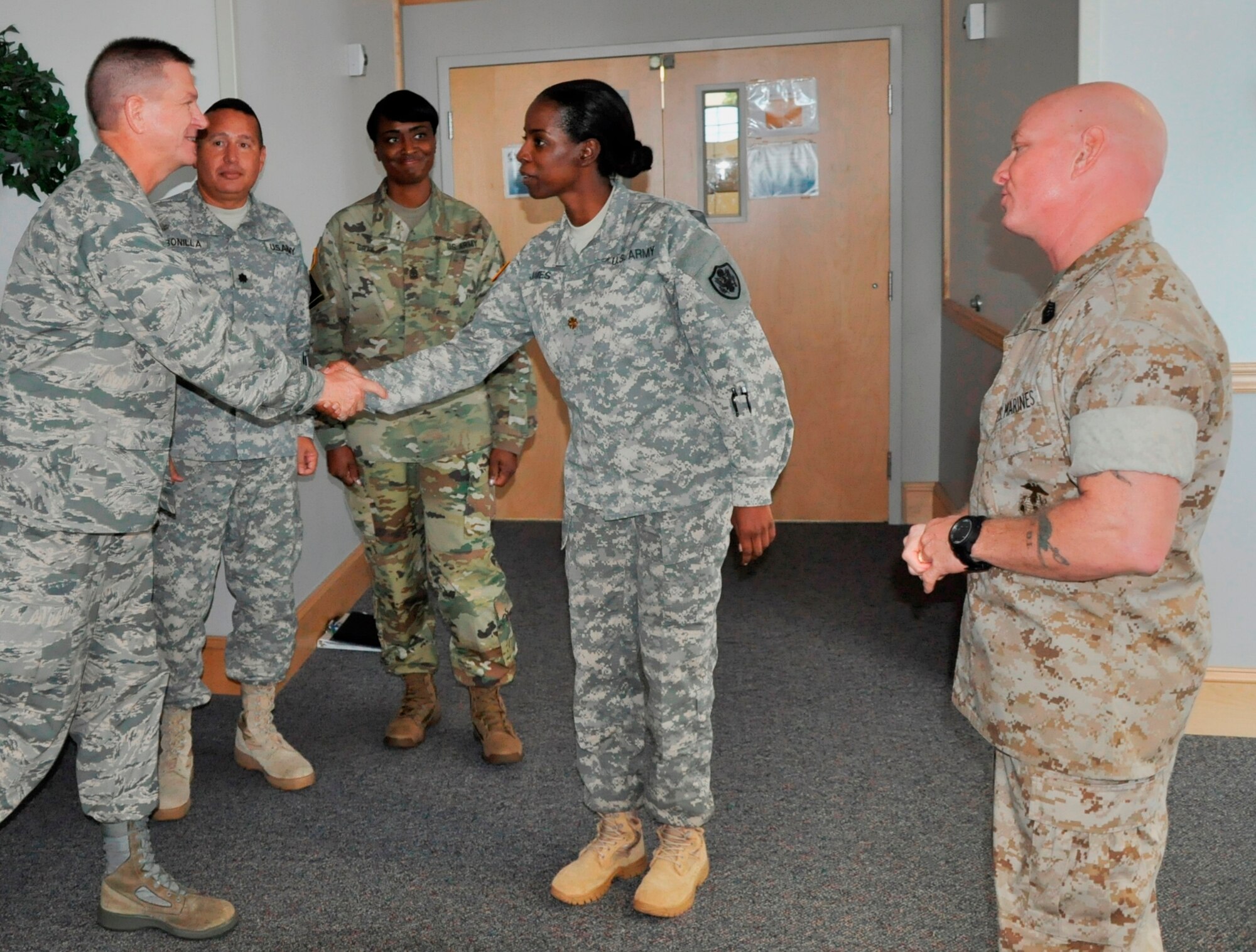 Brig. Gen. Wayne R. Monteith, 45th Space Wing commander, center, shakes hands with Maj. Latoya James during a tour of the Defense Equal Opportunity Management Institute, Oct. 21, 2015. Also pictured are Lt. Col. William Bonilla, second from left, Sgt. Maj. Tina Gray, center, and Master Sgt. Michael Walker, far right. The three Army service members and Marine NCO are all assigned with the DEOMI J-7, Equal Opportunity Training Directorate. (U.S. Air Force photo/Christopher Calkins) 