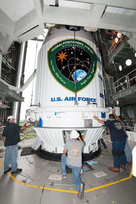 Technicians attach the encapsulated GPS IIF-11 satellite Oct. 21 atop a United Launch Alliance Atlas V 401 launch vehicle in the Vertical Integration Facility near Space Launch Complex 41, Cape Canaveral Air Force Station, Fla. GPS IIF satellites provide improved signals that will enhance the precise global positioning, navigation and timing services supporting both the warfighter and the growing civilian needs of our global economy. GPS IIF satellites provide improved navigational accuracy through advanced atomic clocks, a longer design life than previous GPS satellites, and a third operational civil signal (L5) that benefits commercial aviation and safety-of-life applications. The Air Force and its mission partners are scheduled to launch GPS IIF-11 from SLC-41 at CCAFS on Oct. 30. The launch window opens at 12:17 p.m. EDT and will remain open for 18 minutes. (Courtesy photo: United Launch Alliance)  