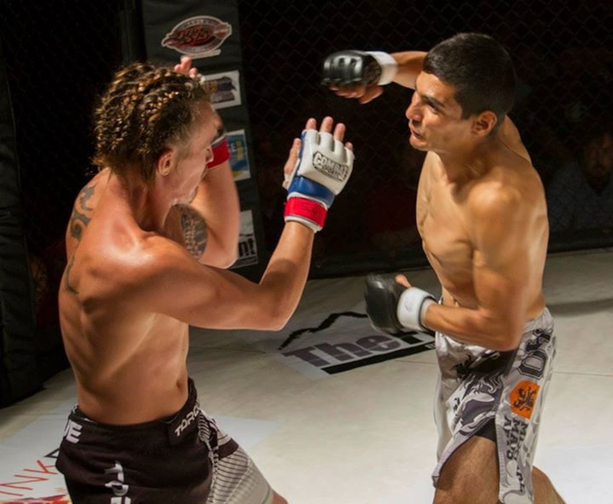 Senior Airman Mark Wirth, 819th RED HORSE Squadron structural engineer, battles his opponent in the mixed martial arts octagon August 23, 2015, in Great Falls, Mont. Wirth currently has a combined record of eight wins and zero losses. (Courtesy photo)