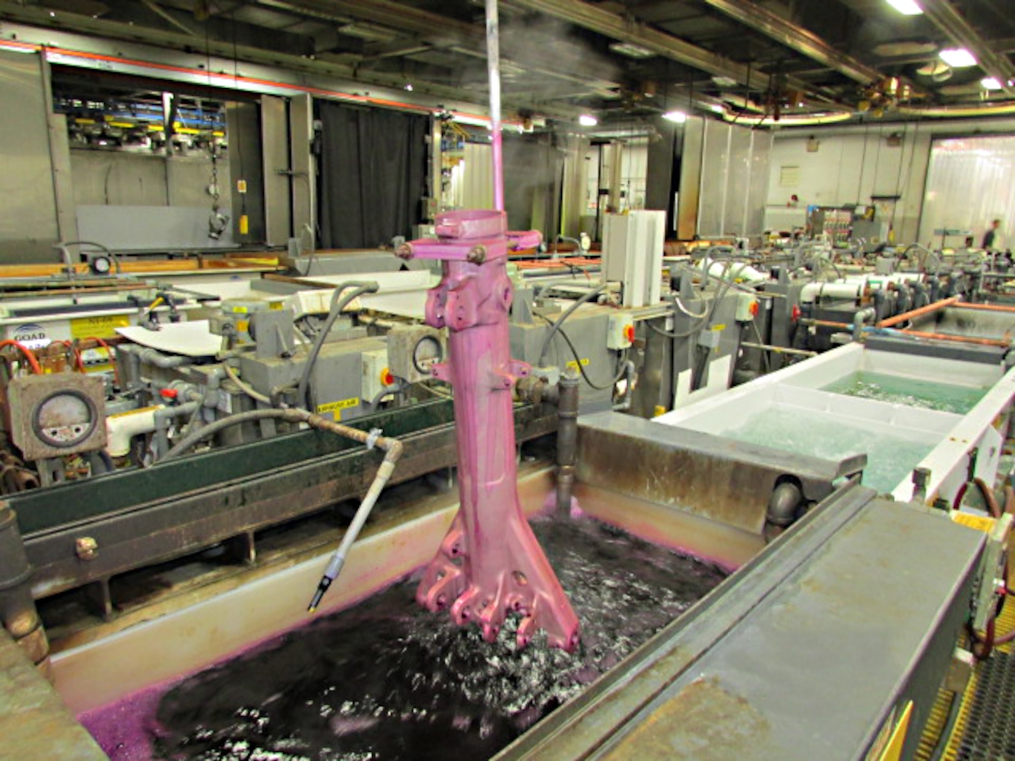 An F-15 outer piston is anodized and sealed with new potassium permanganate sealer at Ogden Air Logistics Complex.  AFRL researchers identified and tested this non-chromium sealer as a safer alternative to chromium-based products, and it is now fully incorporated into OO-ALC’s coating process. (U.S. Air Force Photo)