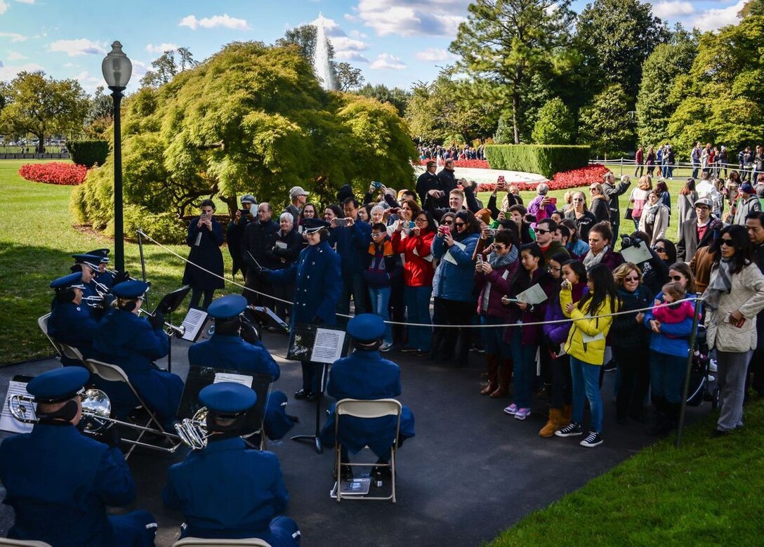 The Ceremonial Brass entertains visitors at the Fall 2015 White House Garden Tour Oct. 18, under the direction of Captain Haley Armstrong. The band played to crowds of hundreds of people who were both waiting in line and walking the White House grounds. (Courtesy photo by Scott Pauley)
