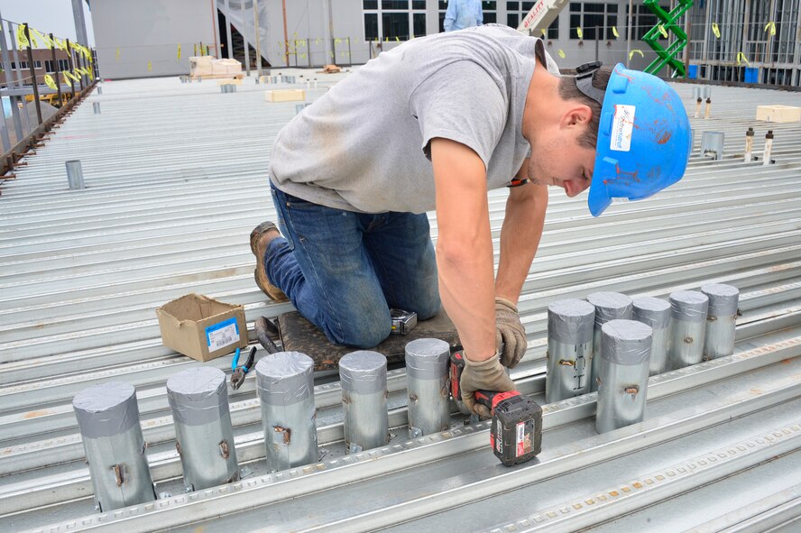 MCGHEE TYSON AIR NATIONAL GUARD BASE, Tenn. - A construction worker installs conduit on support decking on the second floor of dormitory building B here, Oct. 26, 2015, at the I.G. Brown Training and Education Center. Dozens of these conduits must be installed prior to the concrete pad being poured so electrical and plumbing can be ran between floors. (U.S. Air National Guard photo by Master Sgt. Jerry D. Harlan/Released)
