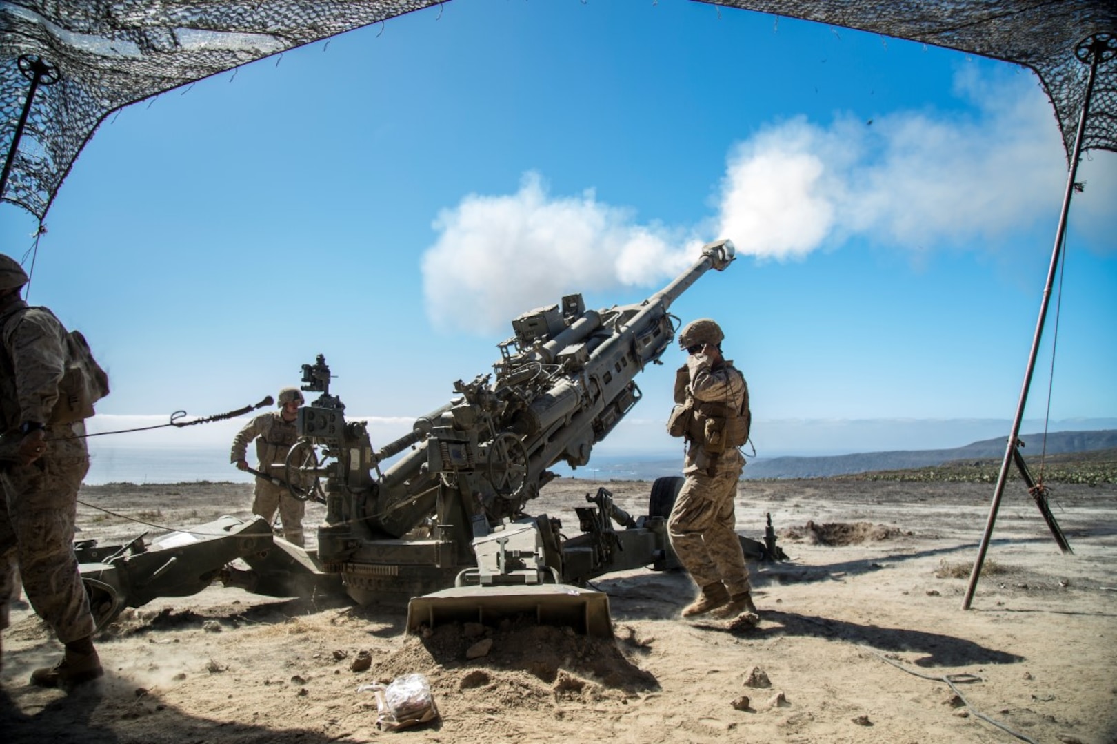 A U.S. Marine with Battery “B”, 2nd Battalion, 1st Marine Regiment, fires a M777A2 Howitzer during Composite Training Unit Exercise (COMPTUEX) at San Clemente Island, Calif., on Oct. 22, 2015. COMPTUEX provides the PHIBRON-MEU the opportunity to integrate planning while also allowing focused, mission-specific training and evaluation for the Marines and their Navy Counterparts. (U.S. Marine Corps photo by Sgt. Hector de Jesus/Released)